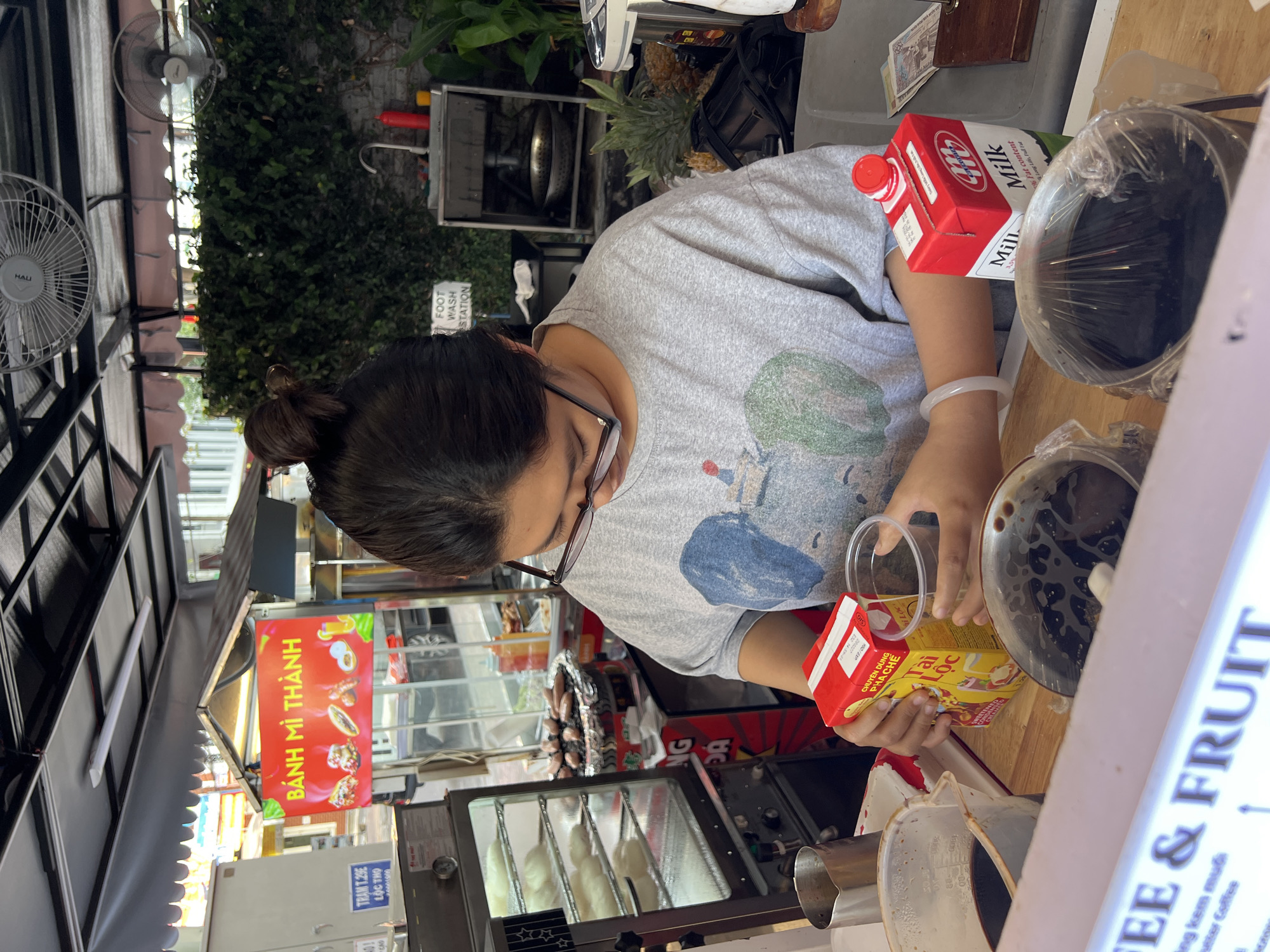 Vendor prepares drink at food stall in Nha Trang