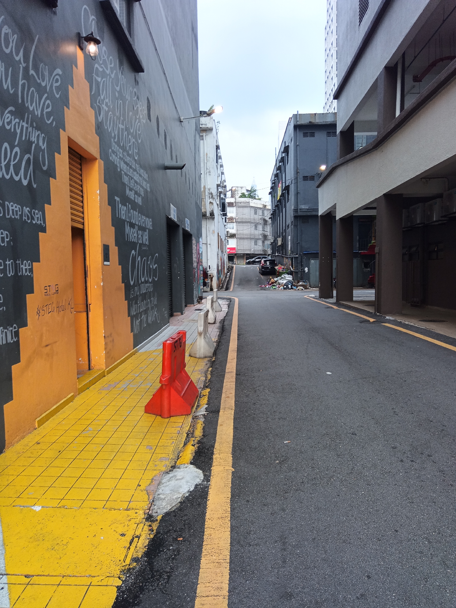 Quiet Sunday morning on a mural-lined Kuala Lumpur backstreet