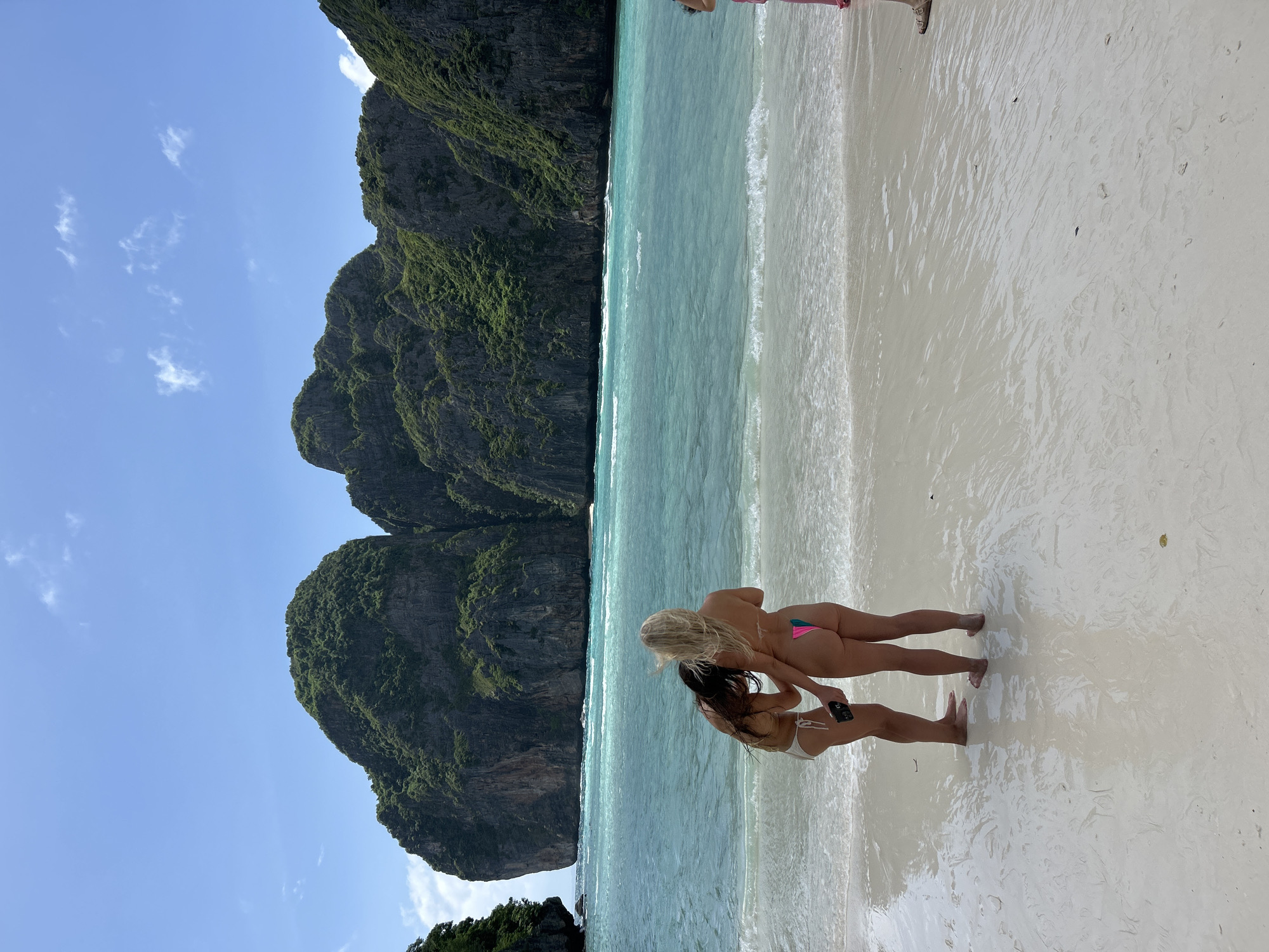 Beach crowds and limestone cliffs at Ao Nang, Krabi