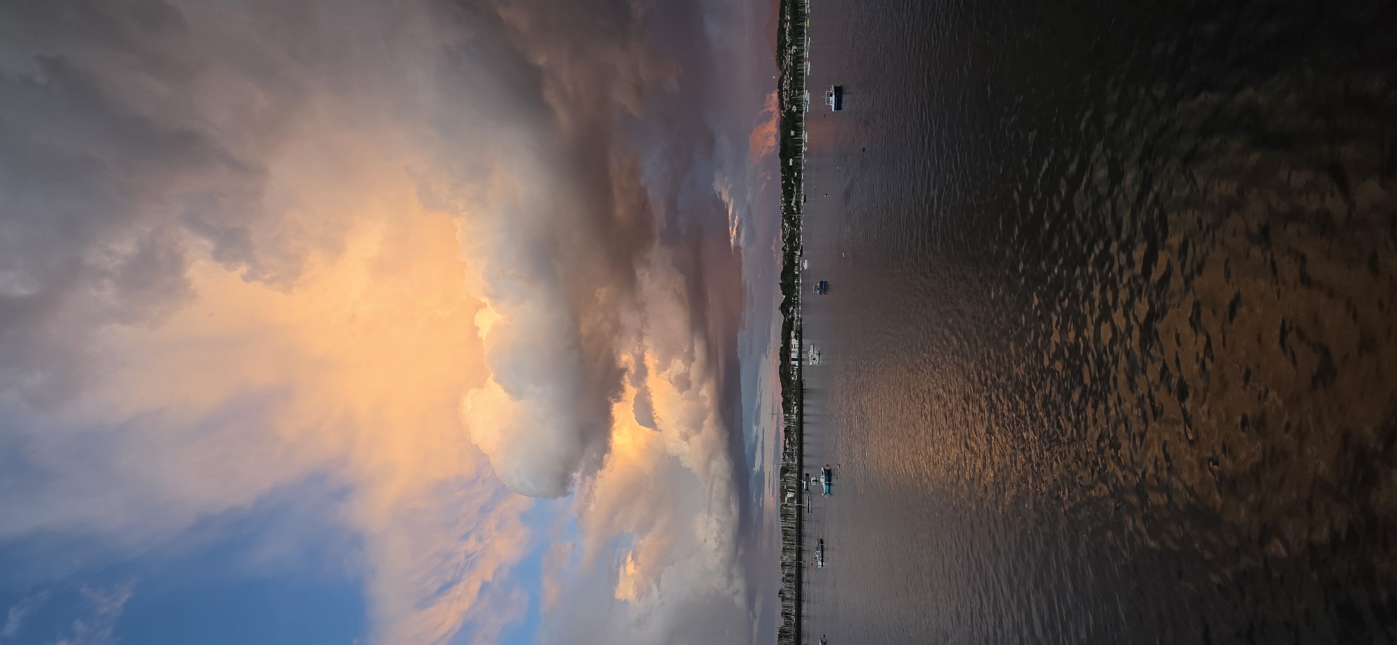 Dramatic sunset captured over Hondarribia waterfront amid storm clouds
