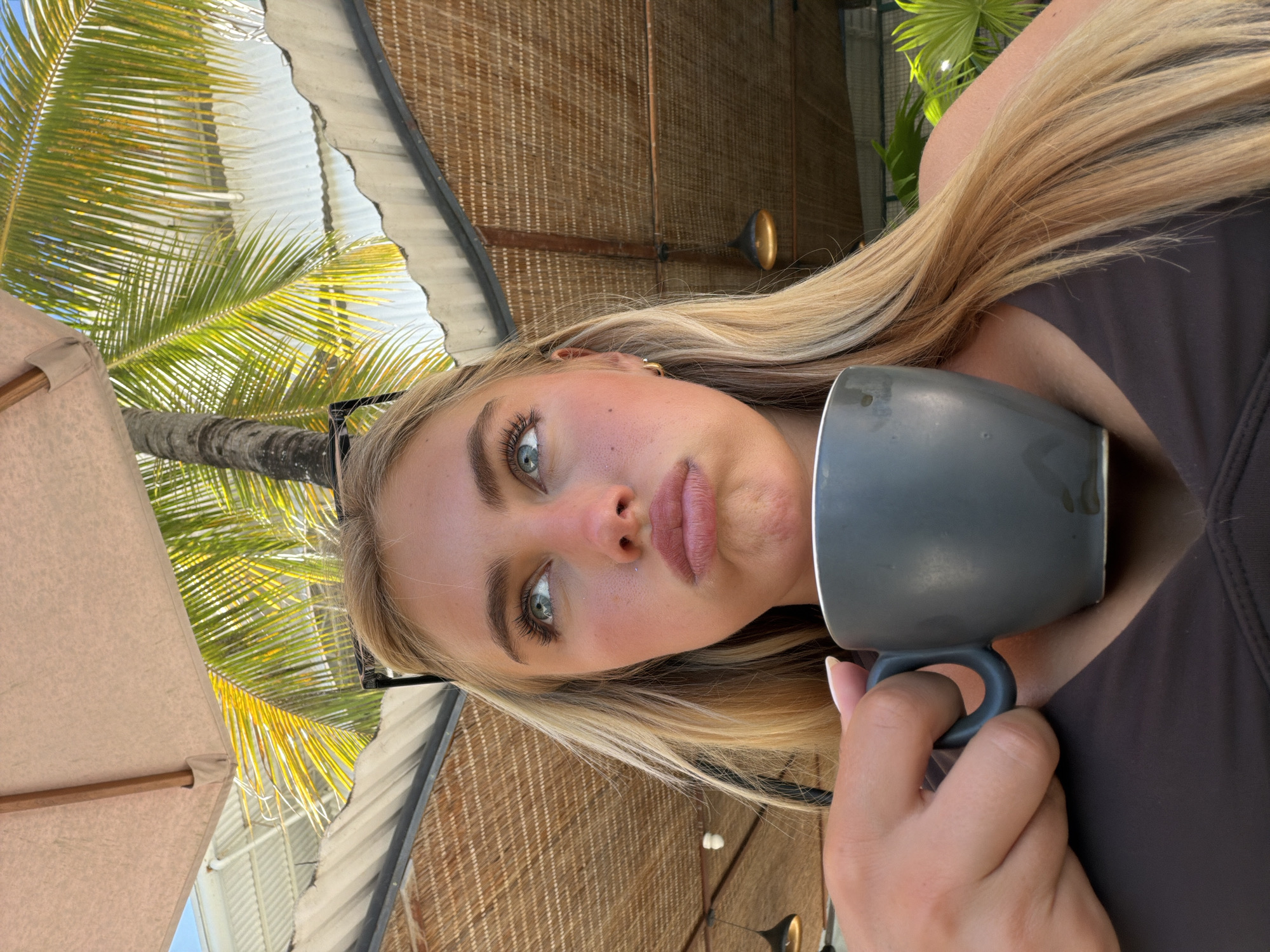 Woman with mug spotted in tropical North Kuta setting