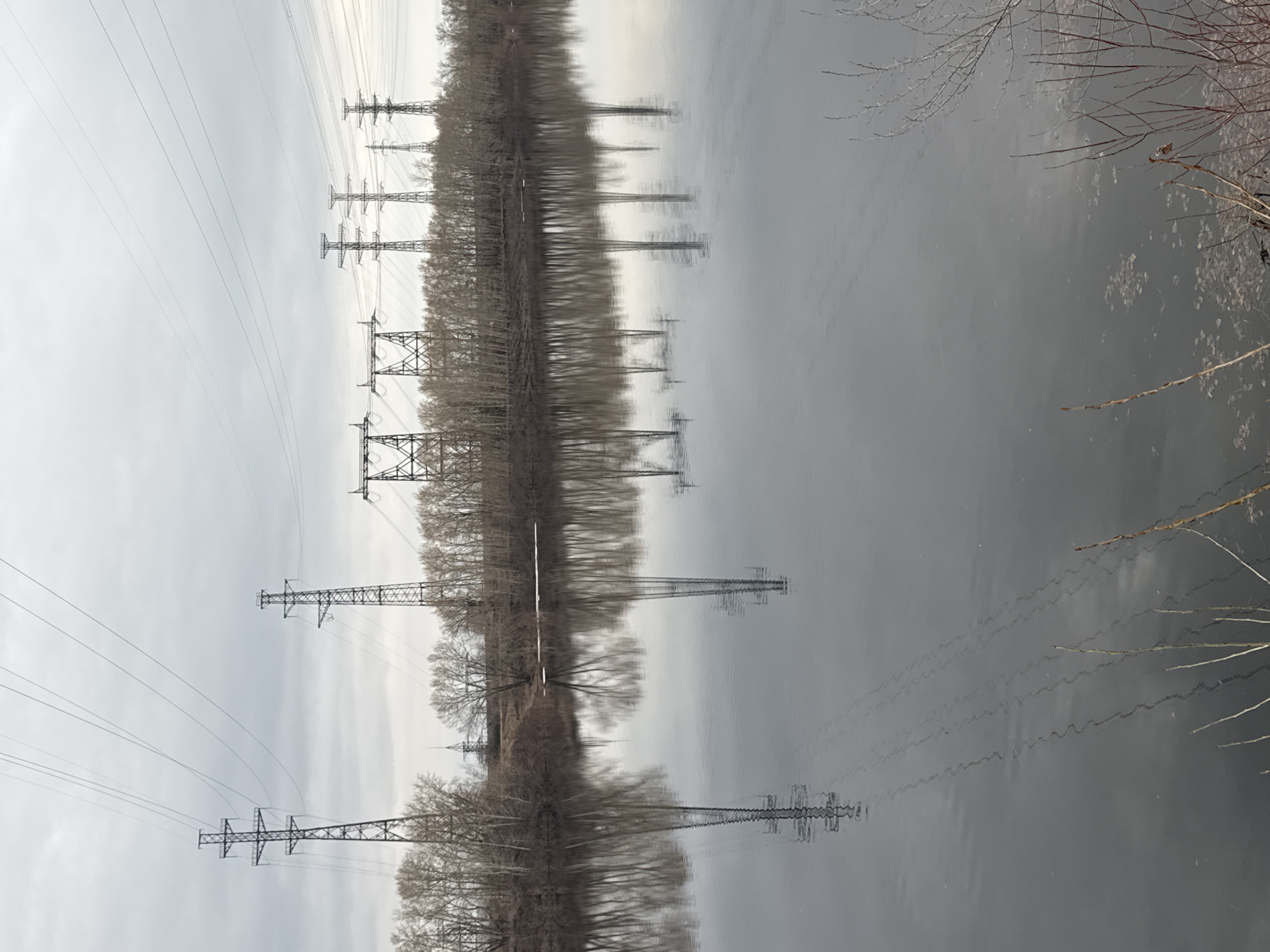 Upside-down river landscape with power lines captured in Chaikovsky