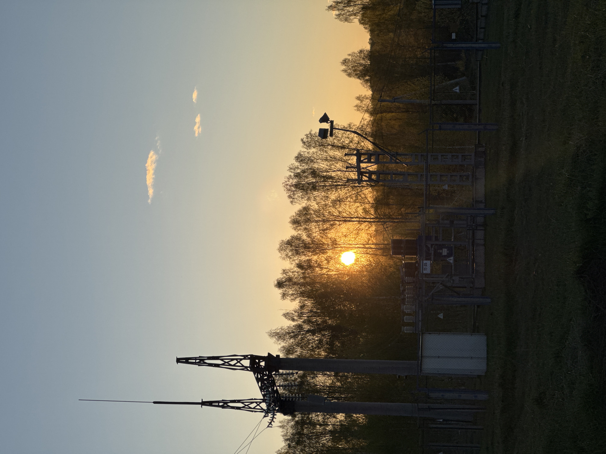 Sunset silhouettes electrical substation in Люкшудья, Russia