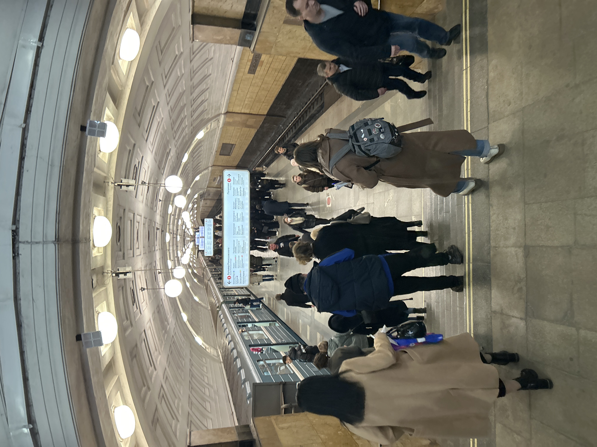 Moscow metro passengers wait on crowded platform during midday