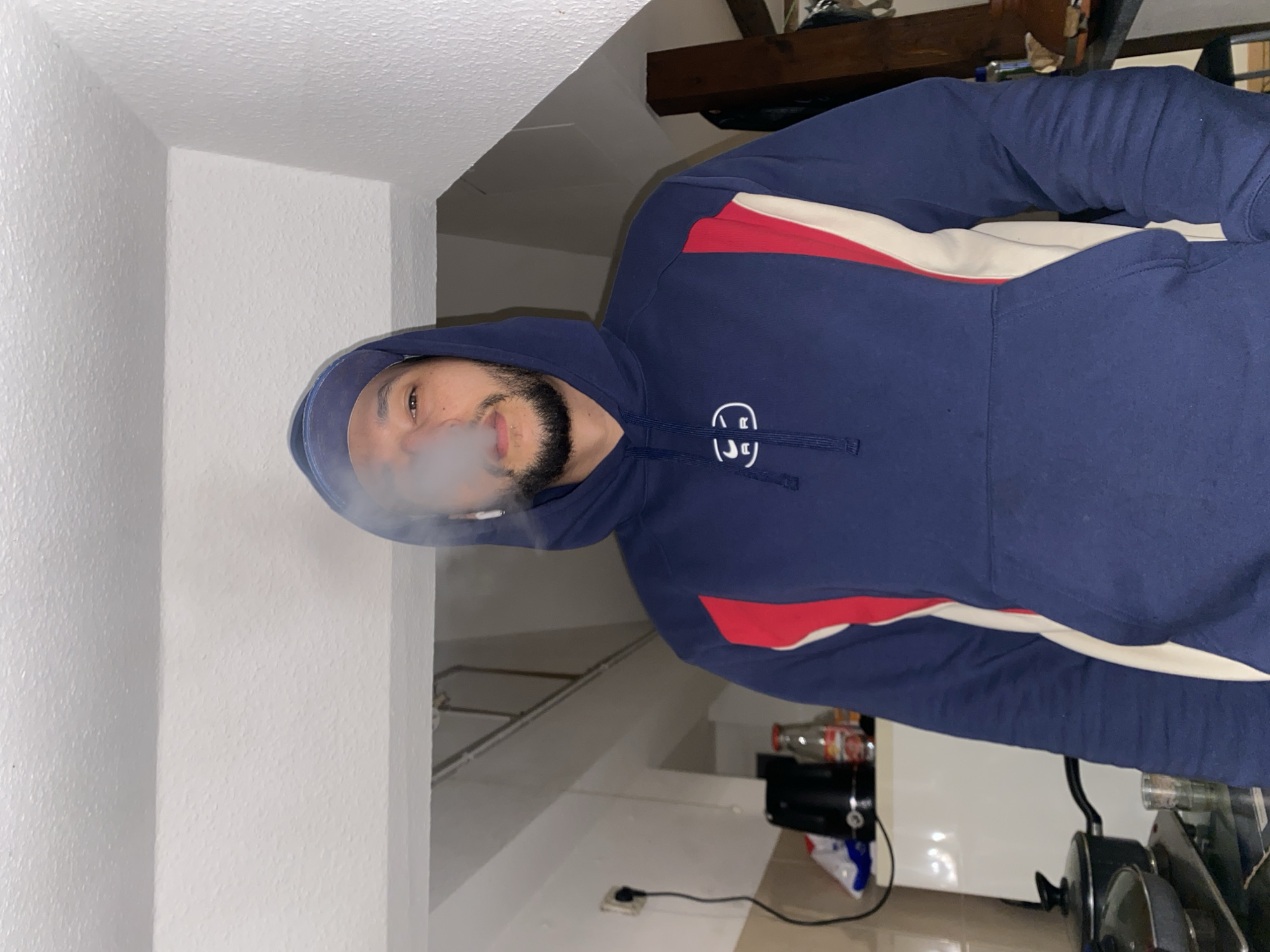 Man smoking indoors in Bischheim kitchen area