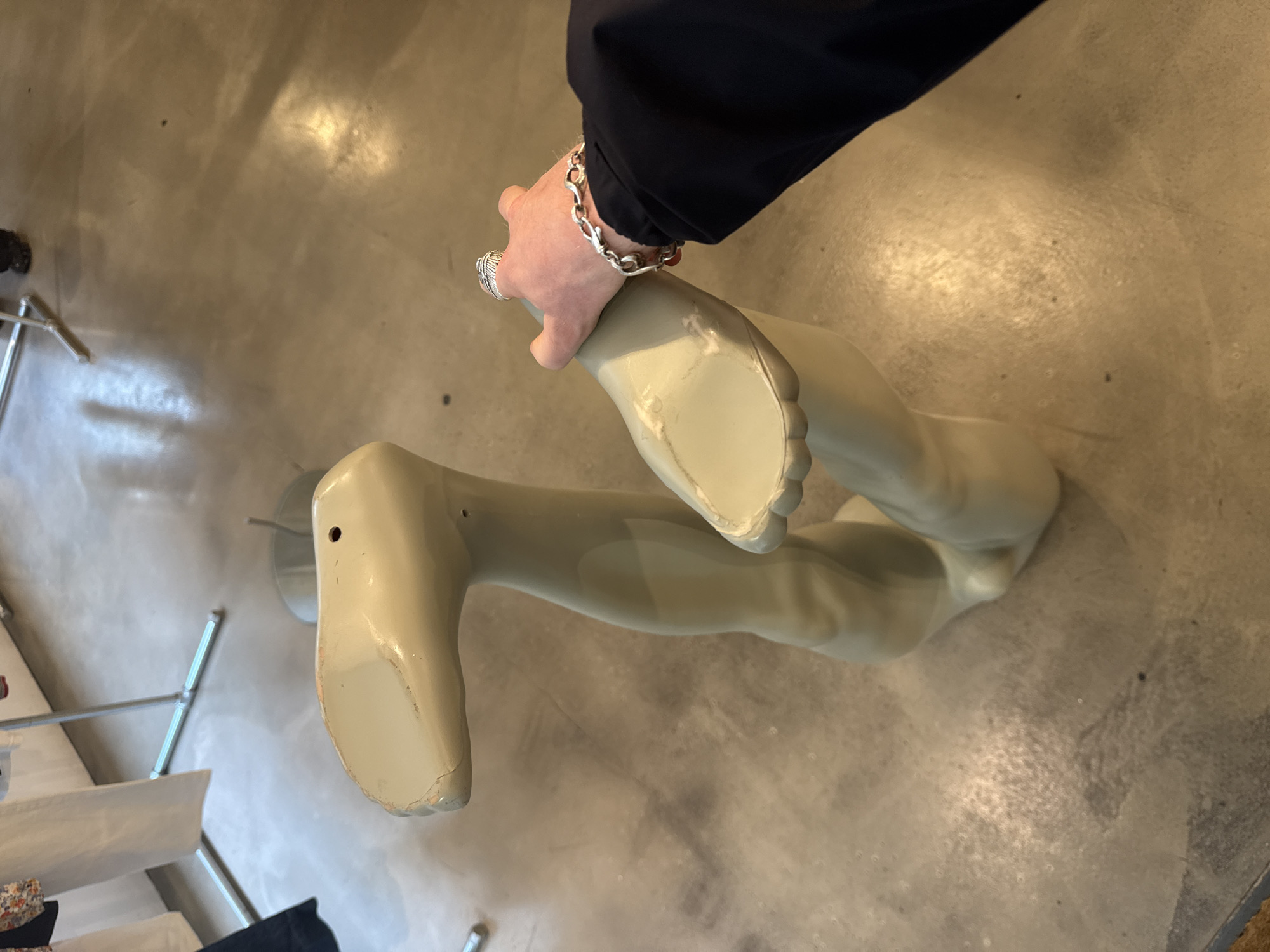 Person handles mannequin parts in London location