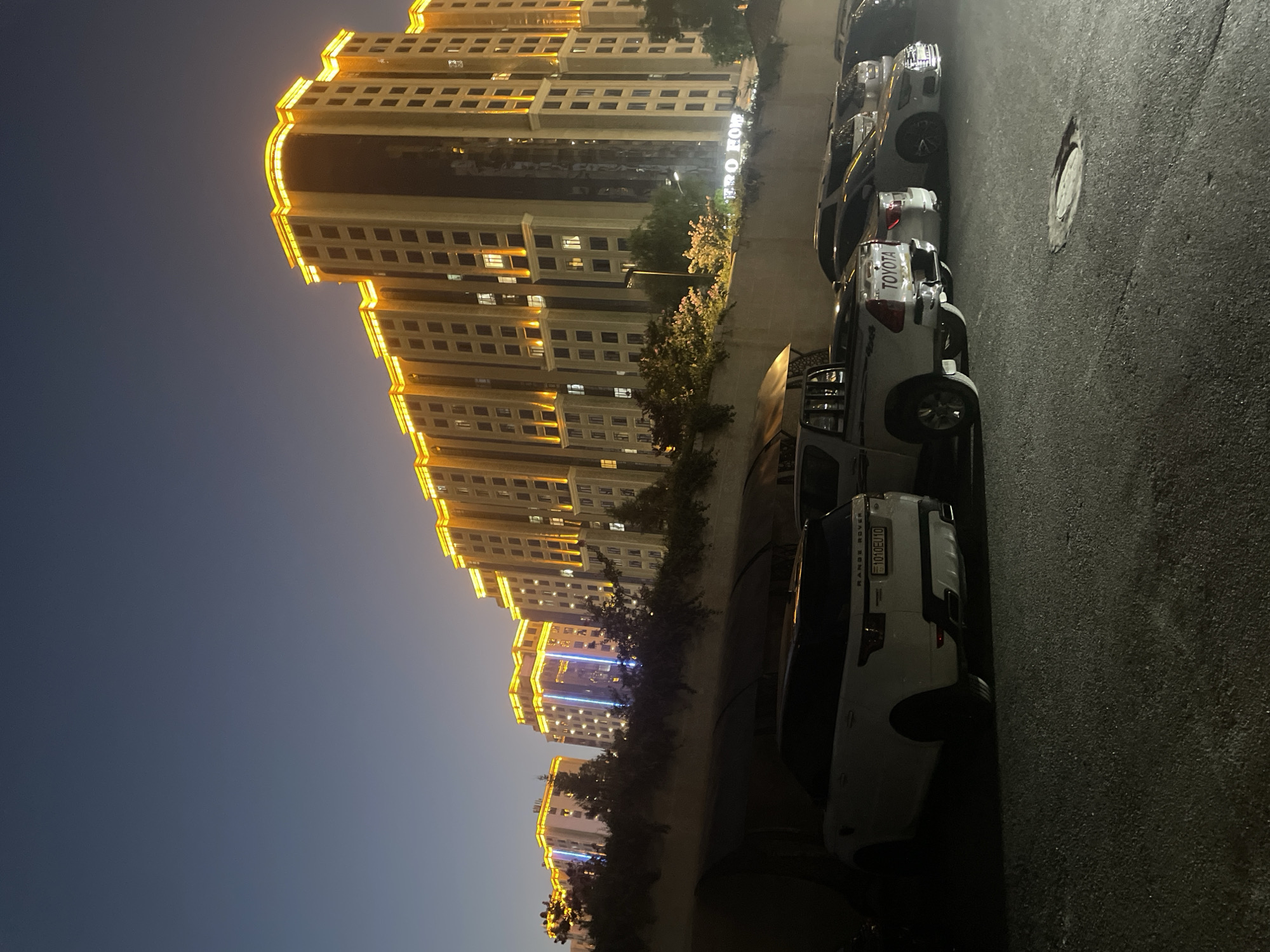 Dushanbe high-rises glow at dusk, street level quiet