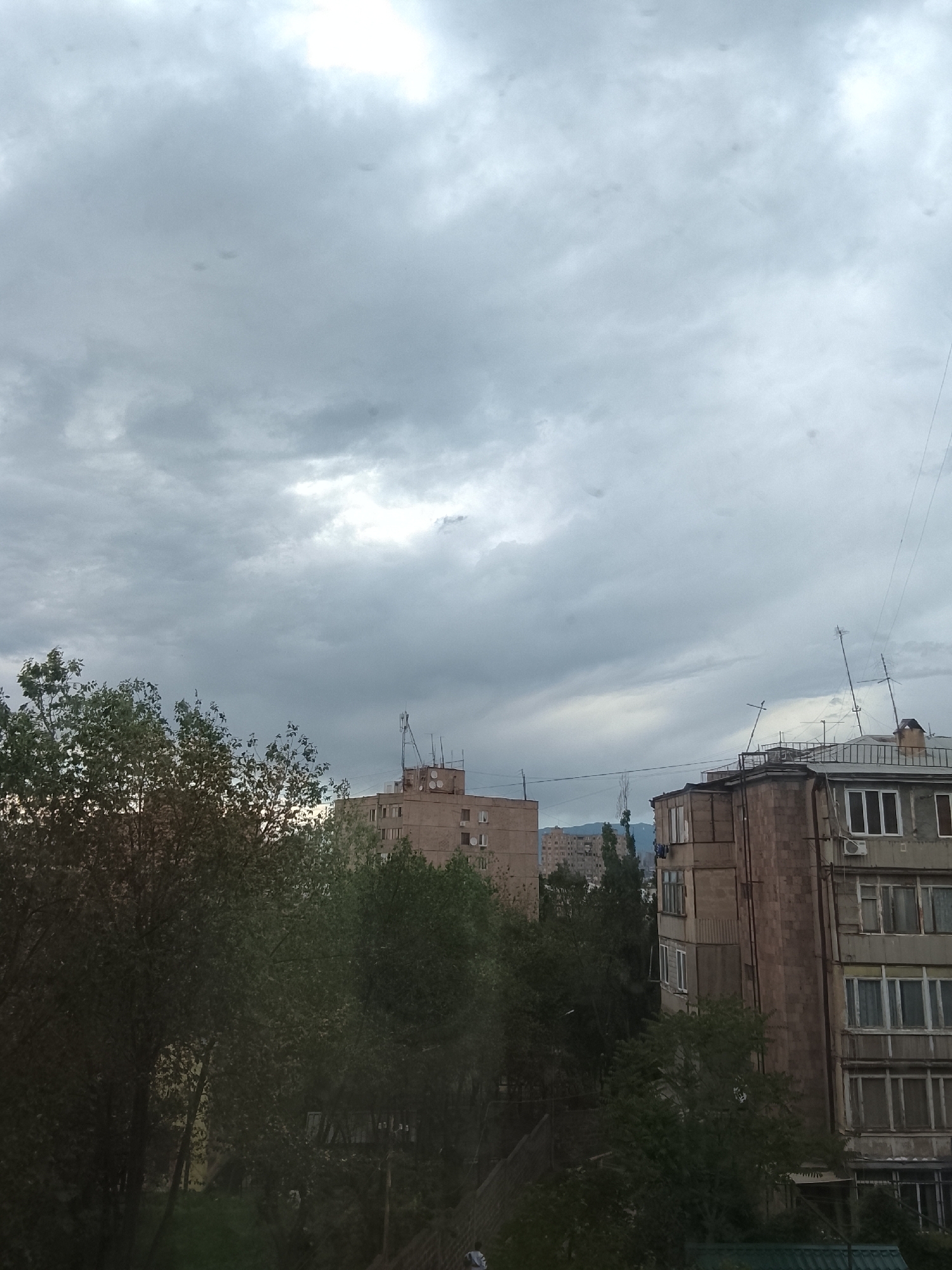 Dramatic cloudy skies documented over urban landscape