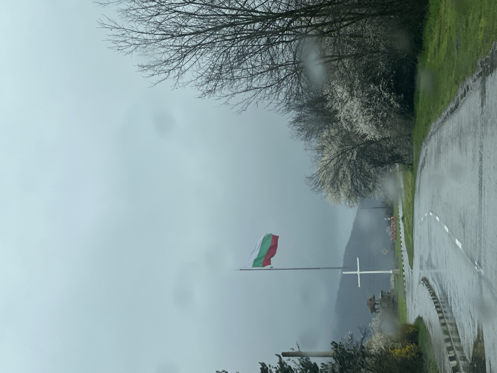 Rainy day scene with Bulgarian flag on Smyadovo road