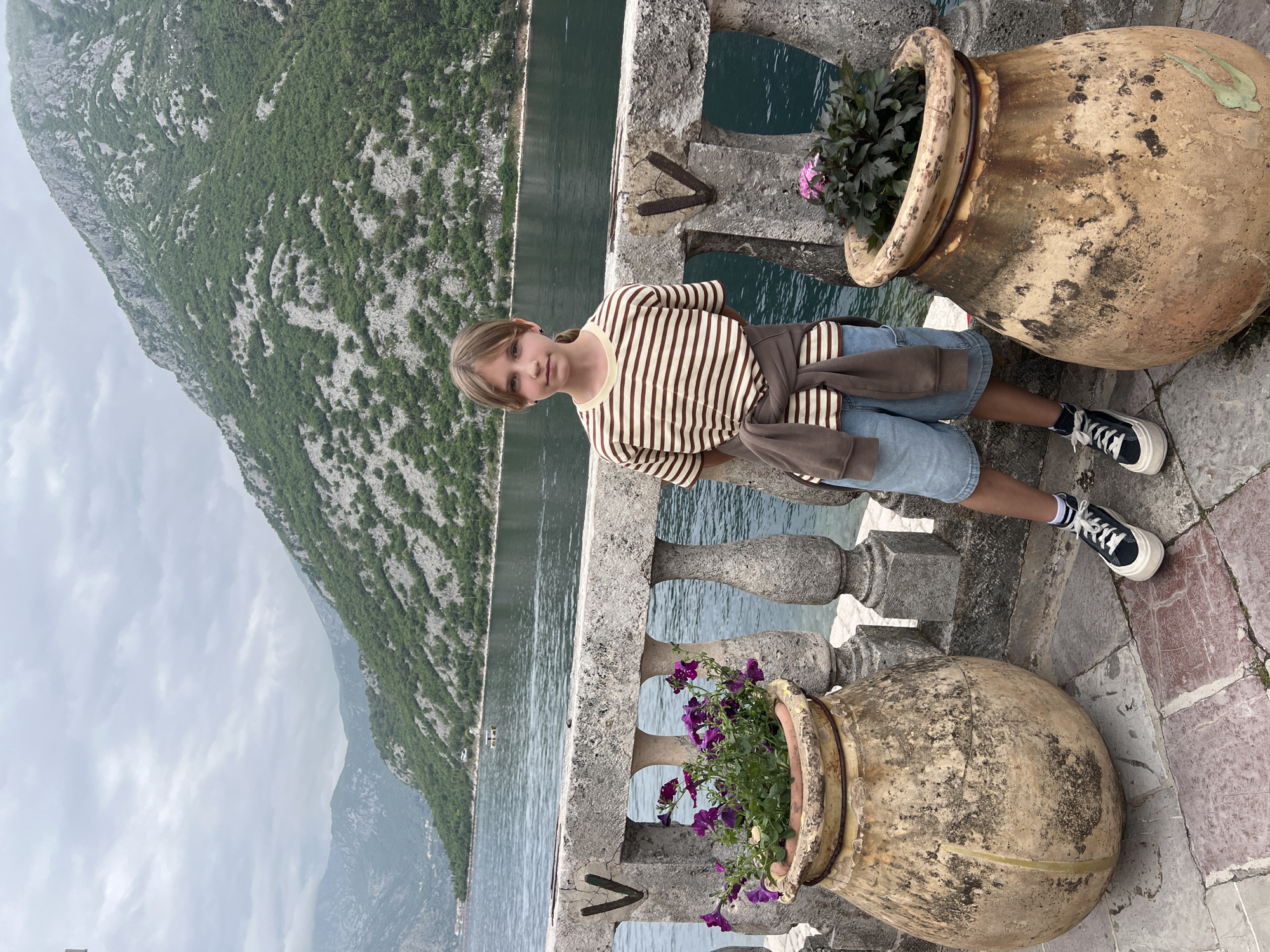 Tourists capture scenic moments in historic Perast, Montenegro