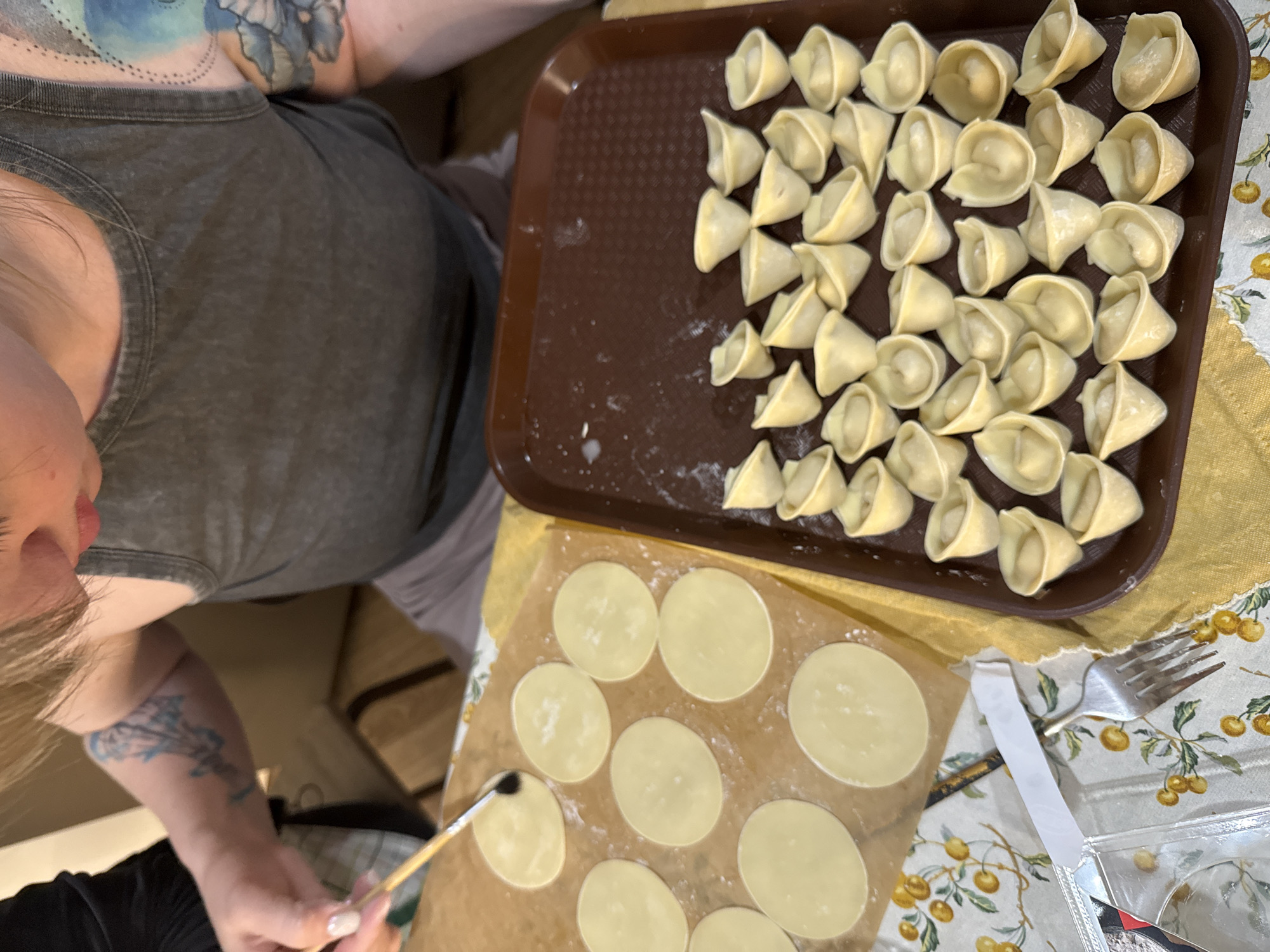 Family dumpling-making session documented in Krasnoyarsk kitchen