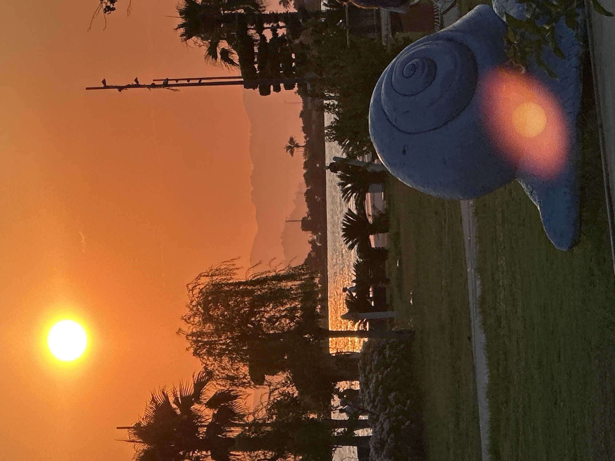 Fethiye waterfront park at sunset: exercise, sculpture, golden skies