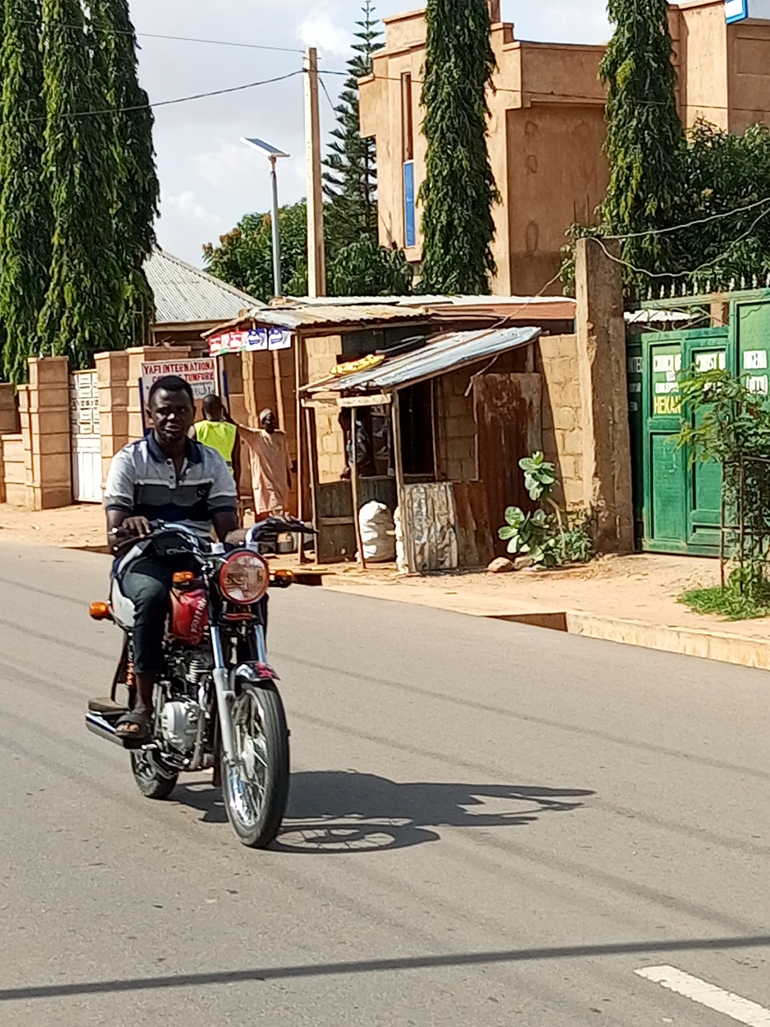 Motorcycle riding through the streets of Tempure, Nigeria