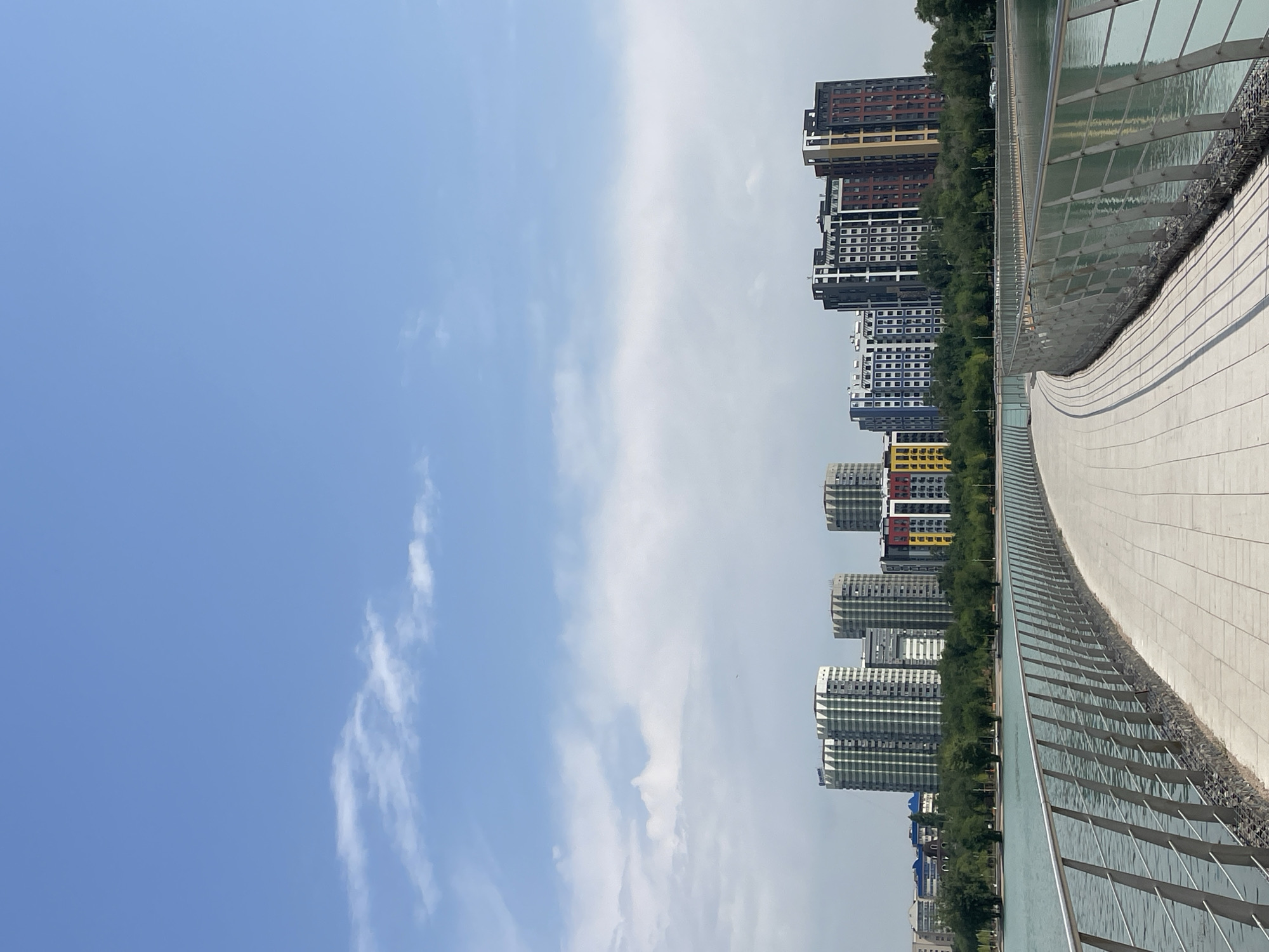Almaty lakeside park in active use on a summer morning