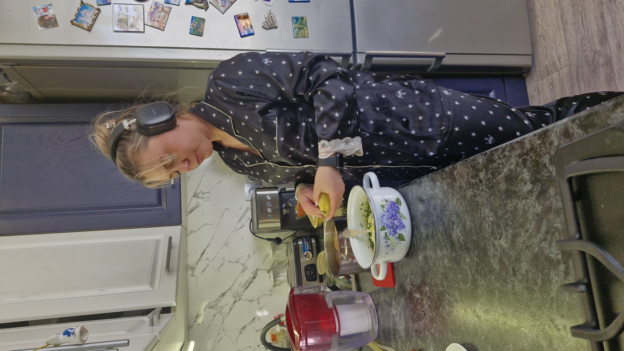 Woman prepares breakfast in kitchen wearing star-patterned pajamas