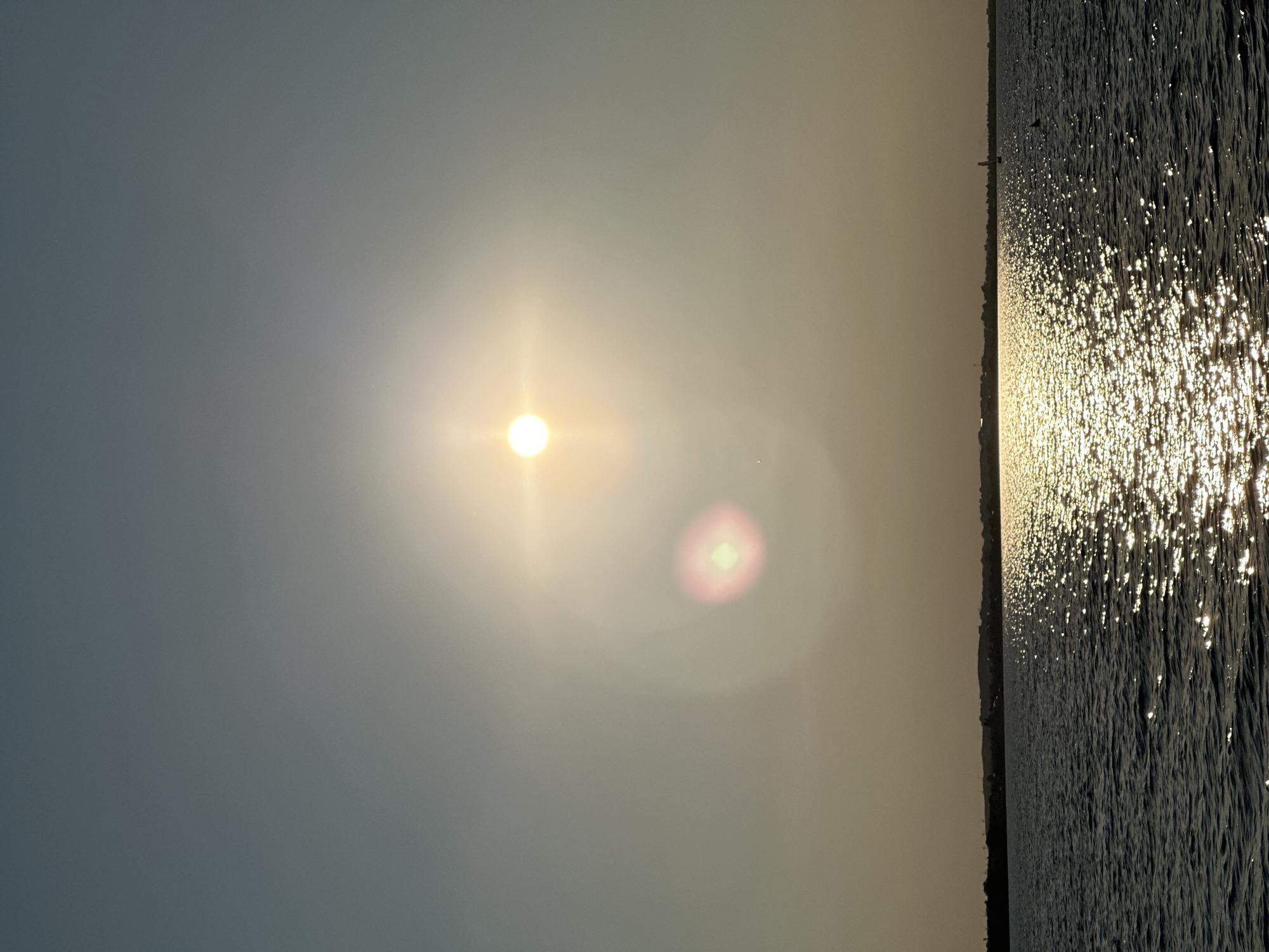Sun glare and golden reflections over a Kokshetau lake