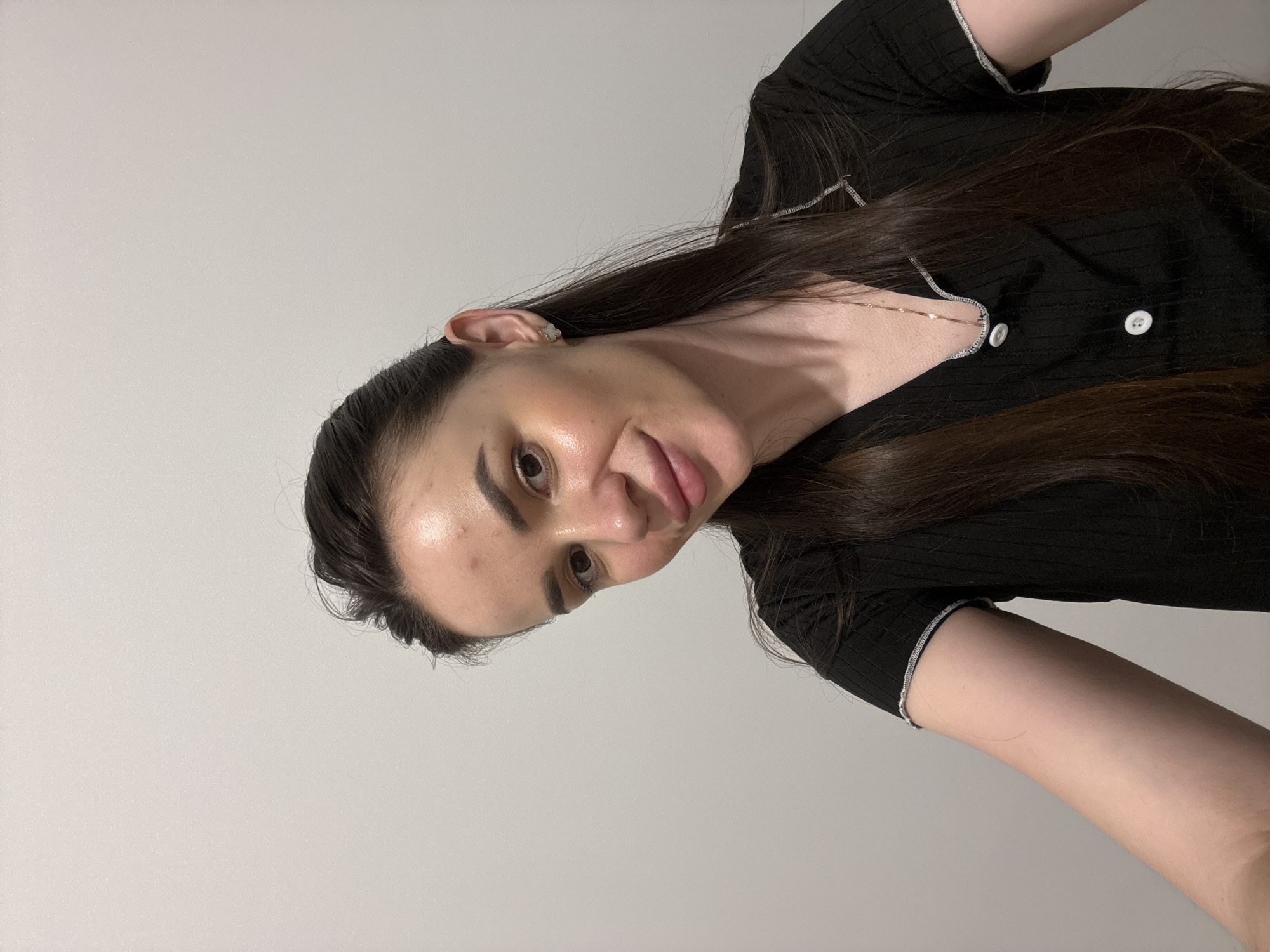 Quick back-to-back selfies against a plain white wall.