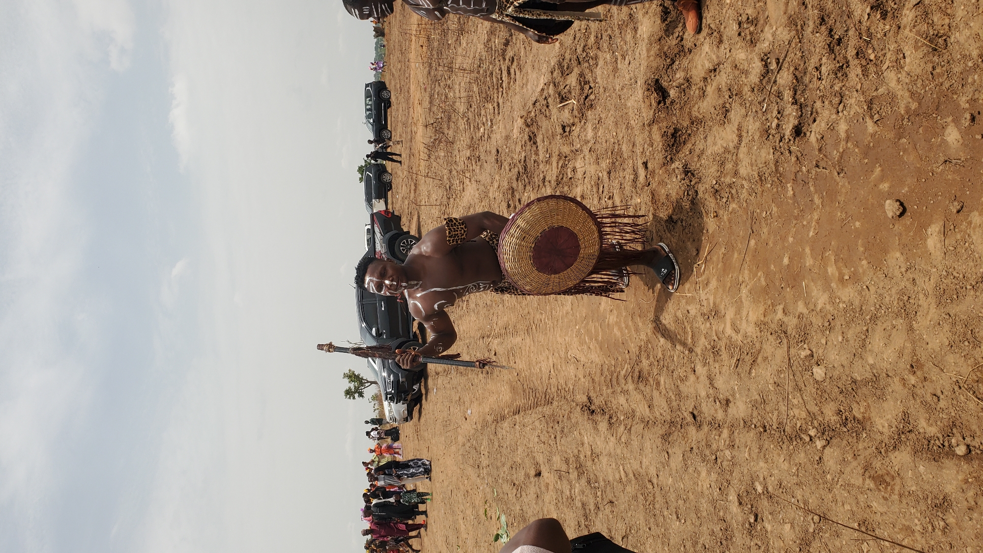 Four men pose with traditional paint, leopard print in Akwanga