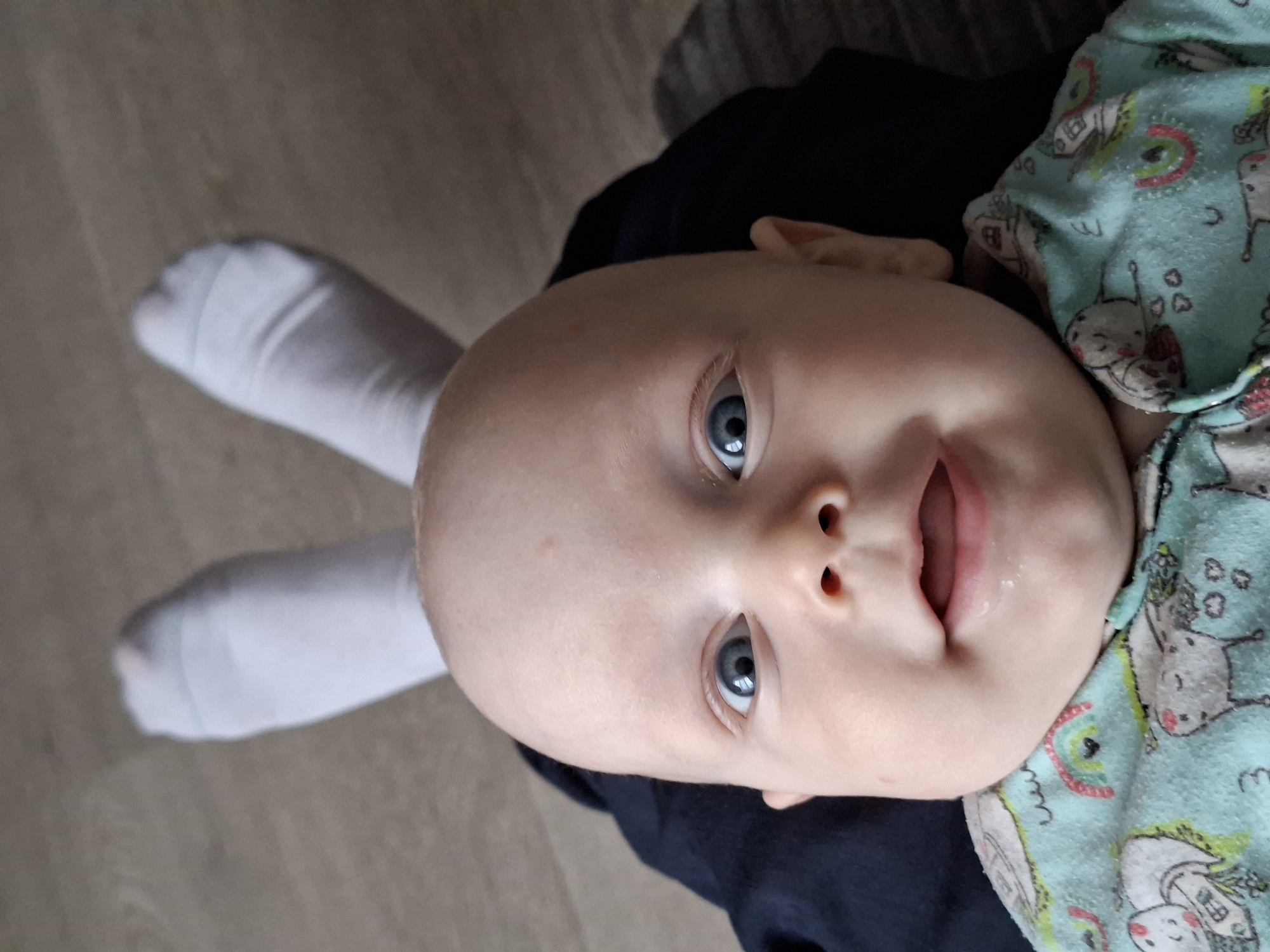 Baby photographed with socks arranged as makeshift rabbit ears