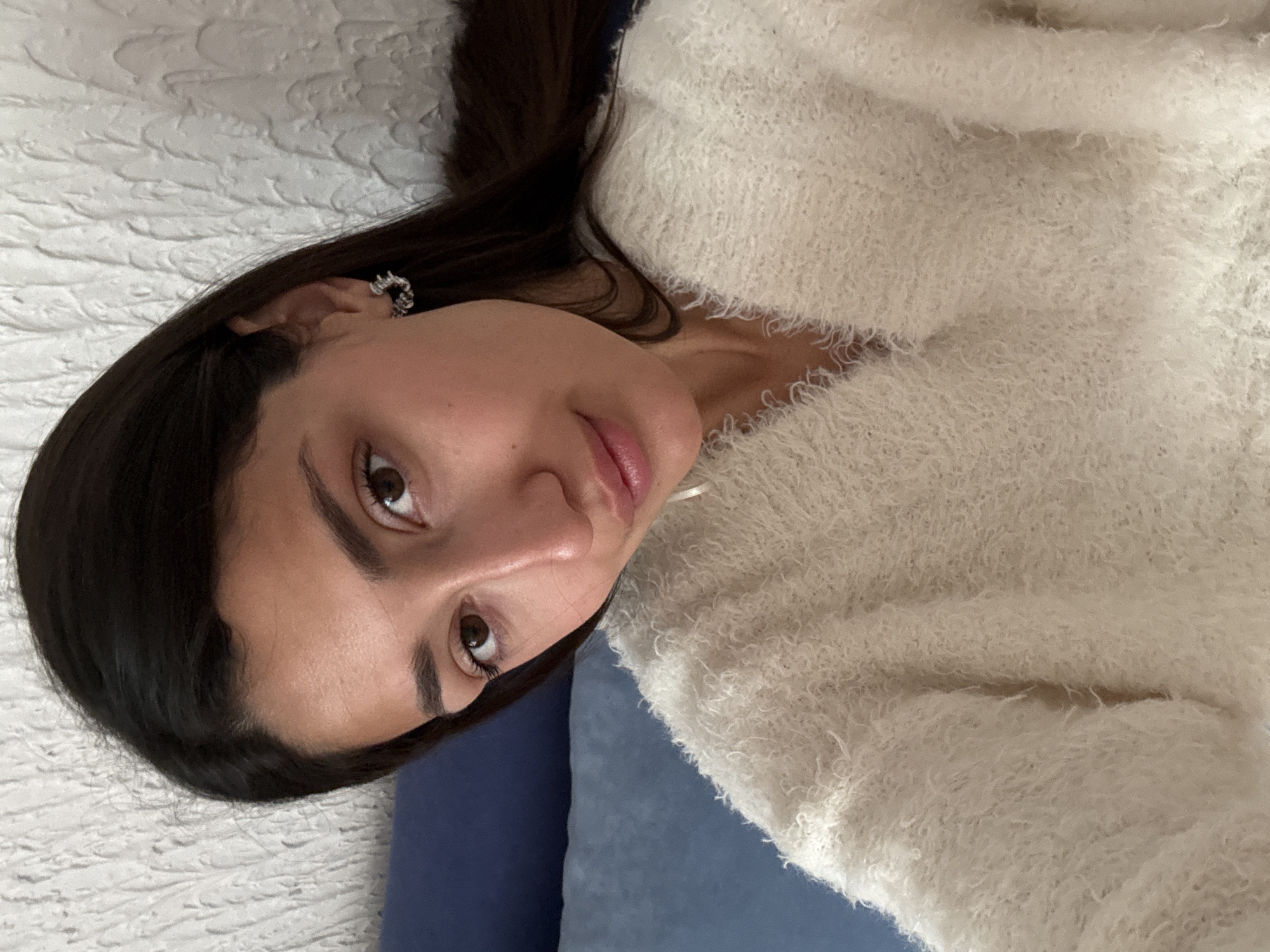 Woman in sweater resting on white surface in Montenegro