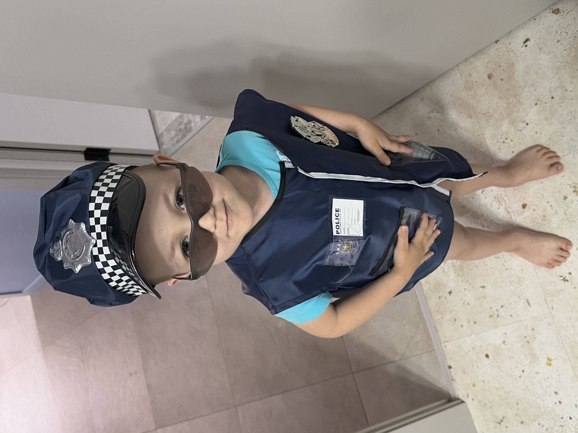 Mother and child play police dress-up in Chaikovsky home