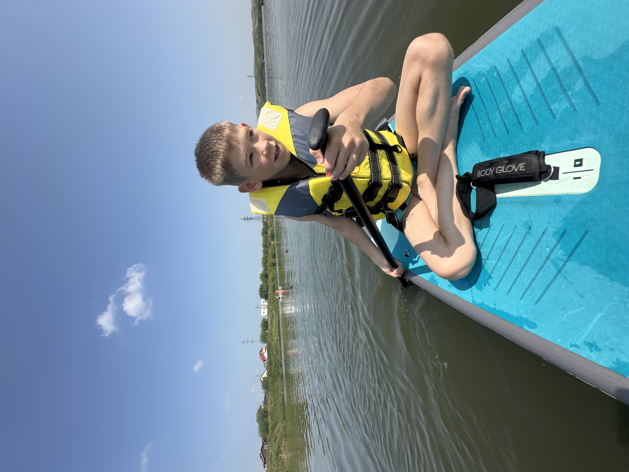 Relaxed paddleboarding session on calm, reflective water
