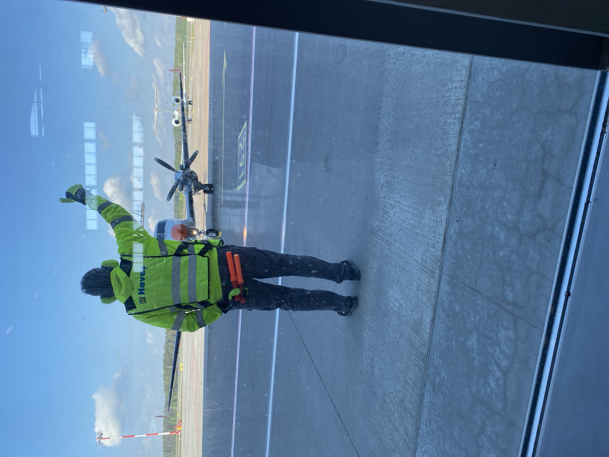 Ground crew directs aircraft operations at Skulte airport