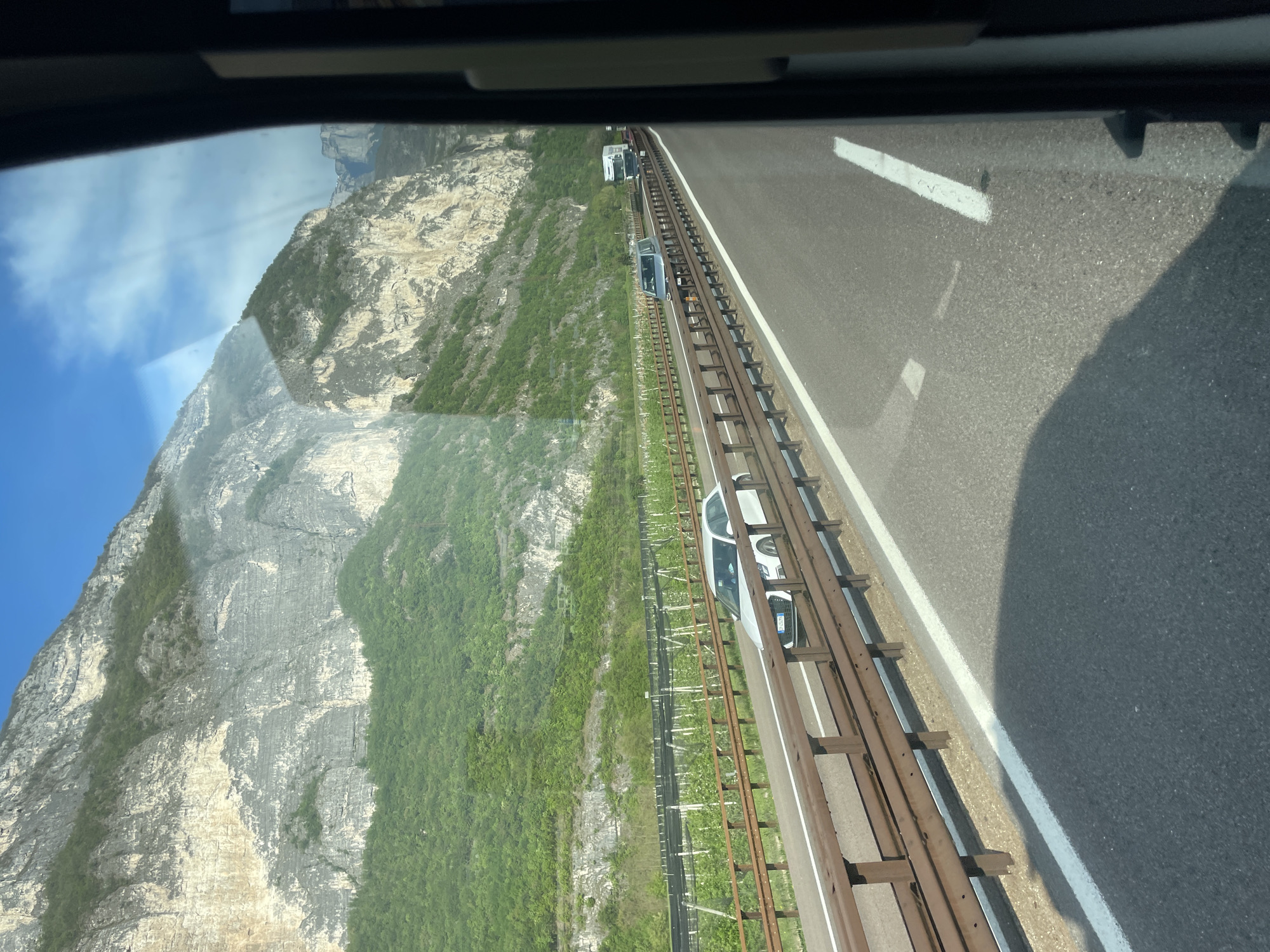 Morning traffic flows through mountain highway near Trento