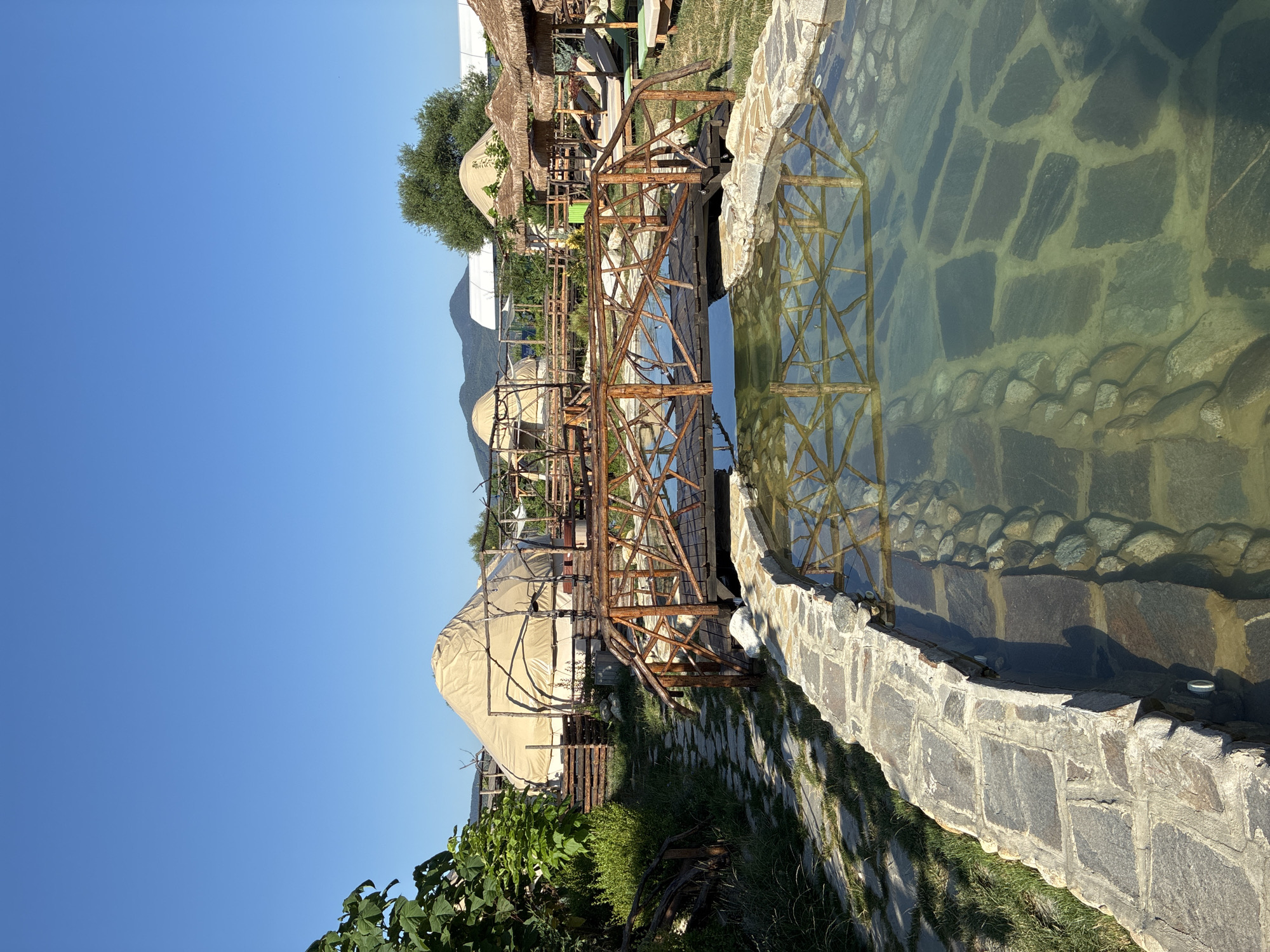 Natural stone pool and glamping setup in Velingrad, Bulgaria