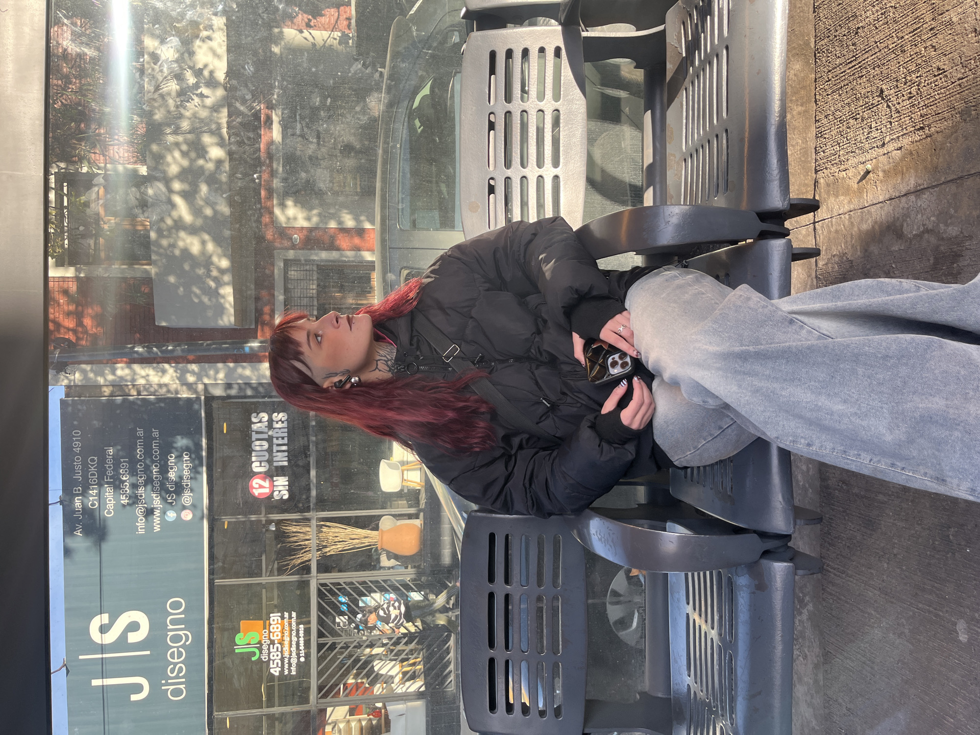 Woman waits at Buenos Aires bus stop Sunday evening