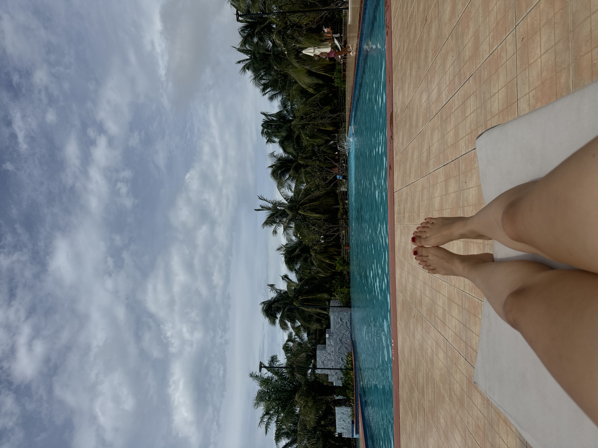 Lazy poolside afternoon under cloudy skies in Phú Thủy