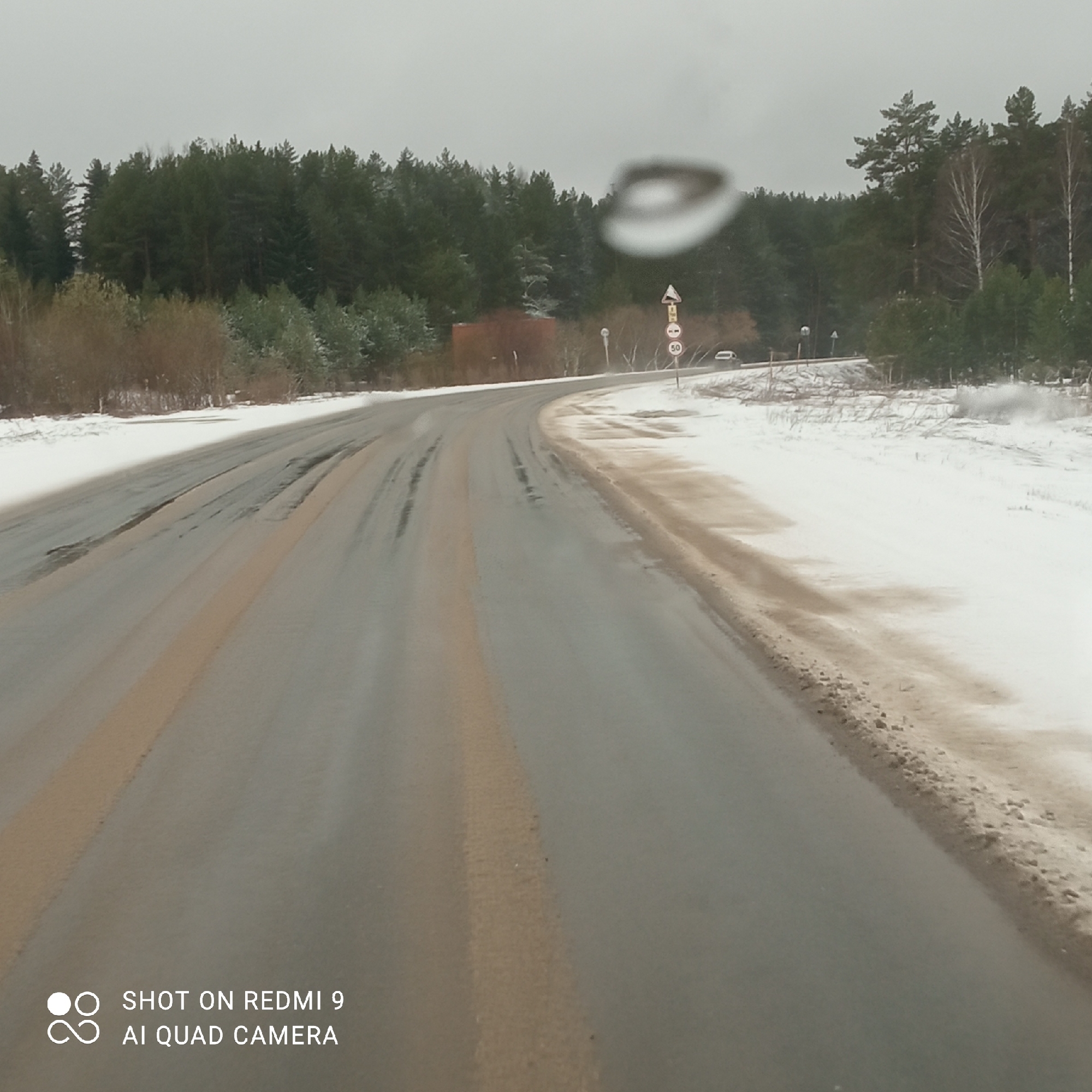 Snowy road conditions documented in Прикамский, Russia