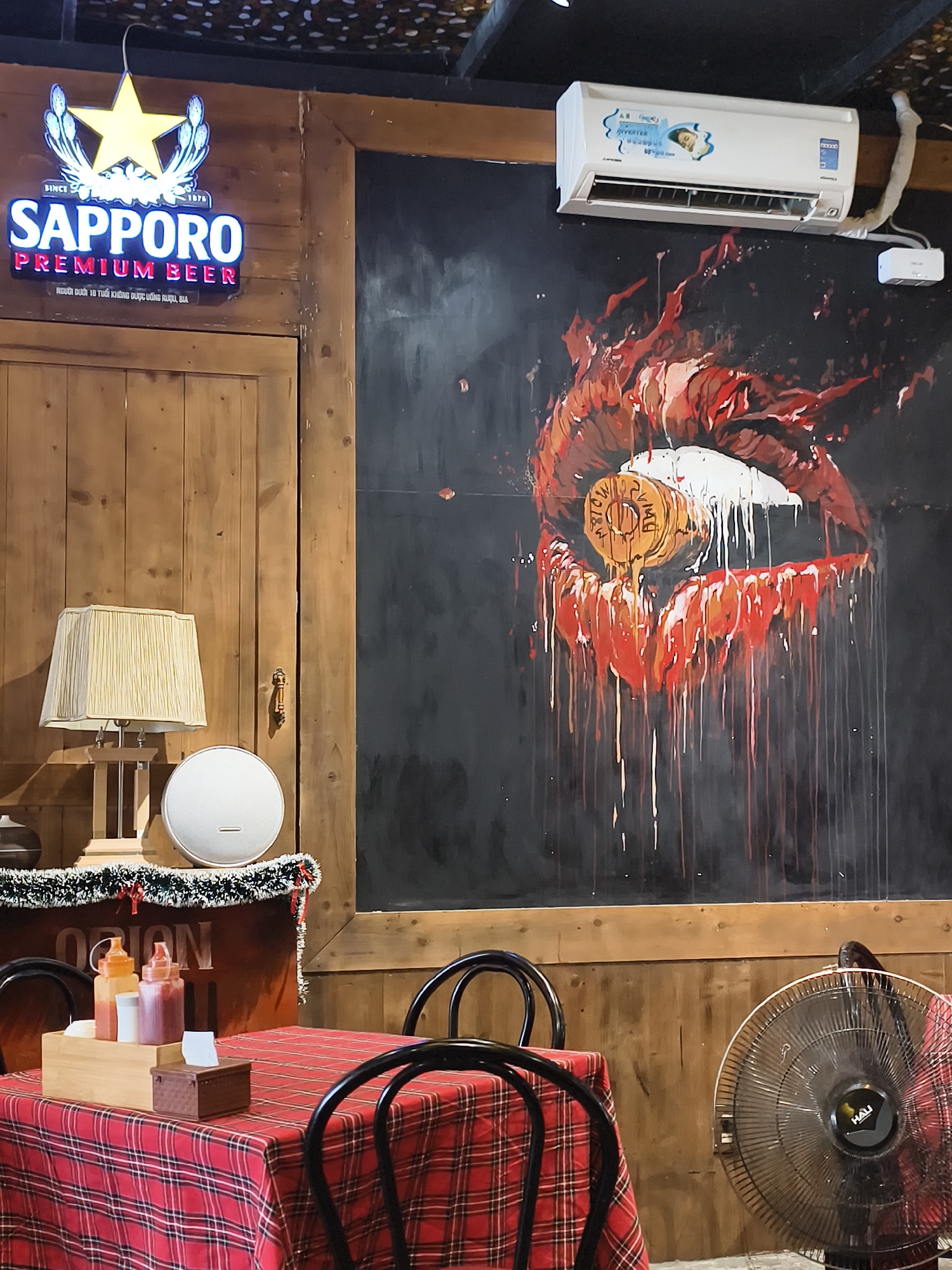 Restaurant interior with Sapporo beer sign documented by witness