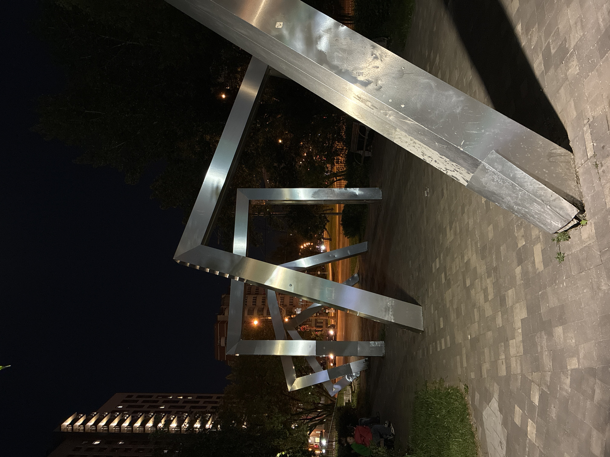 Illuminated metal sculpture installation documented in nighttime Moscow