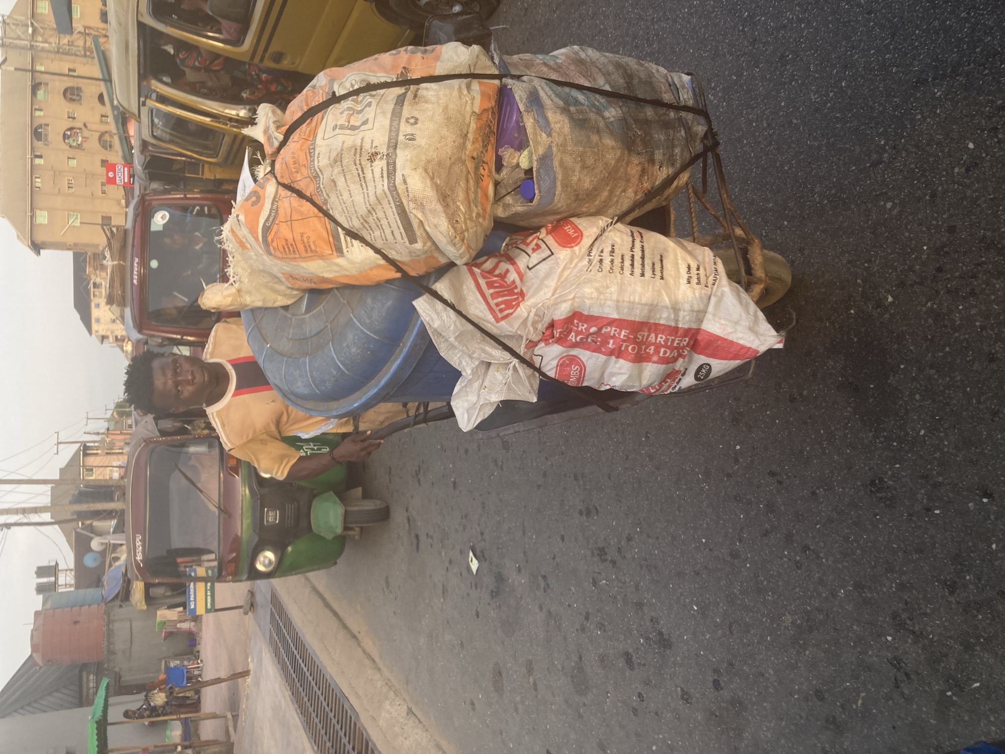 Daily life unfolds on Umuode streets during sunset hour