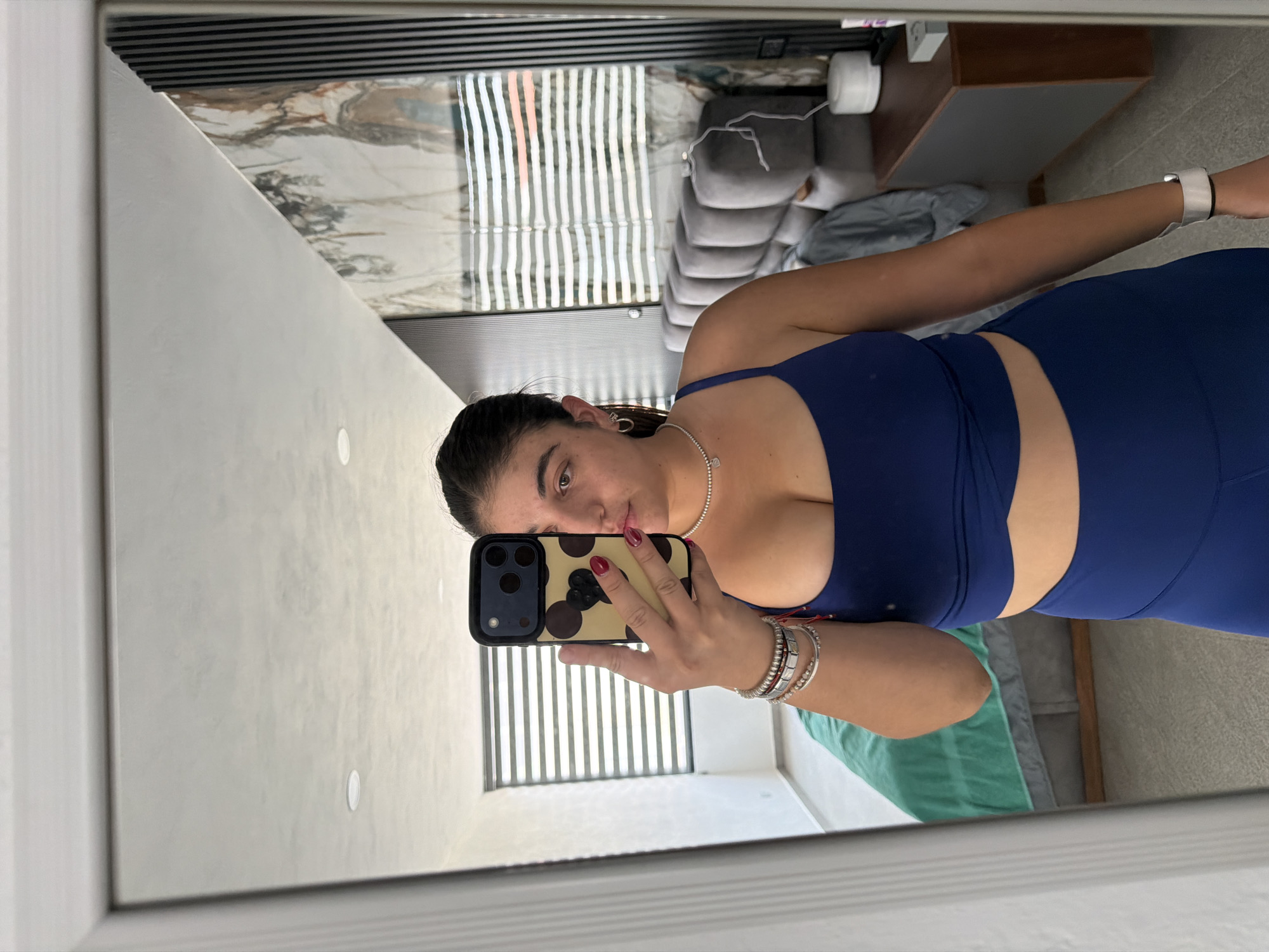 Woman documents evening routine with selfies, pet in Puebla bedroom