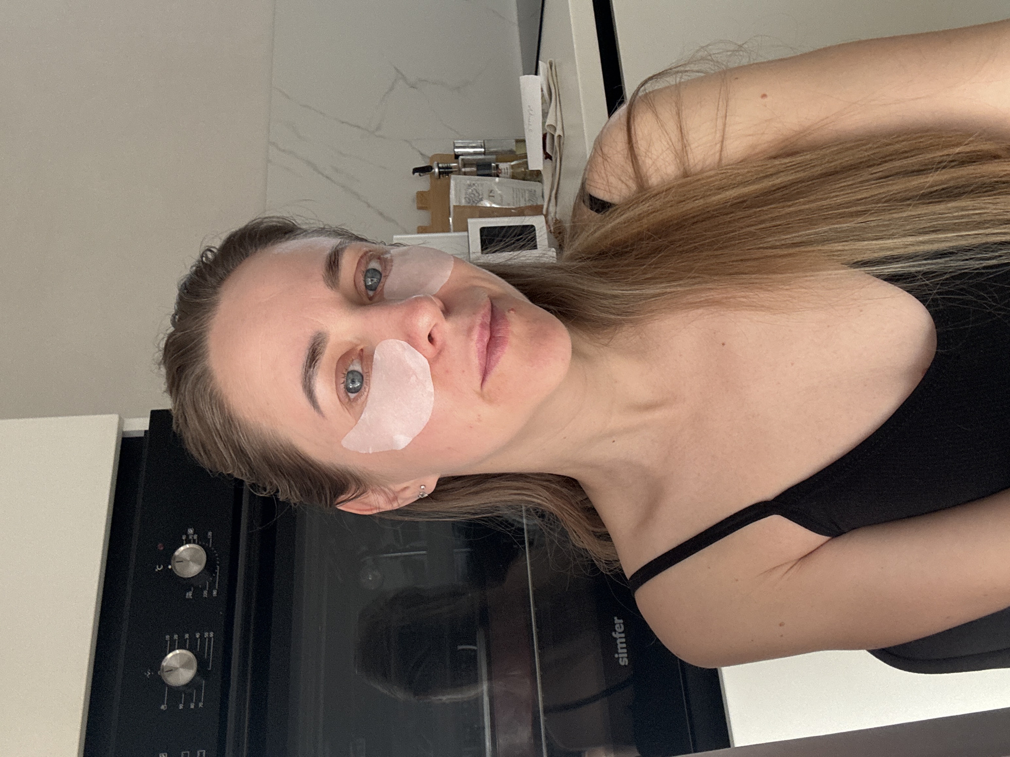 Woman's morning skincare routine documented in Chaikovsky kitchen