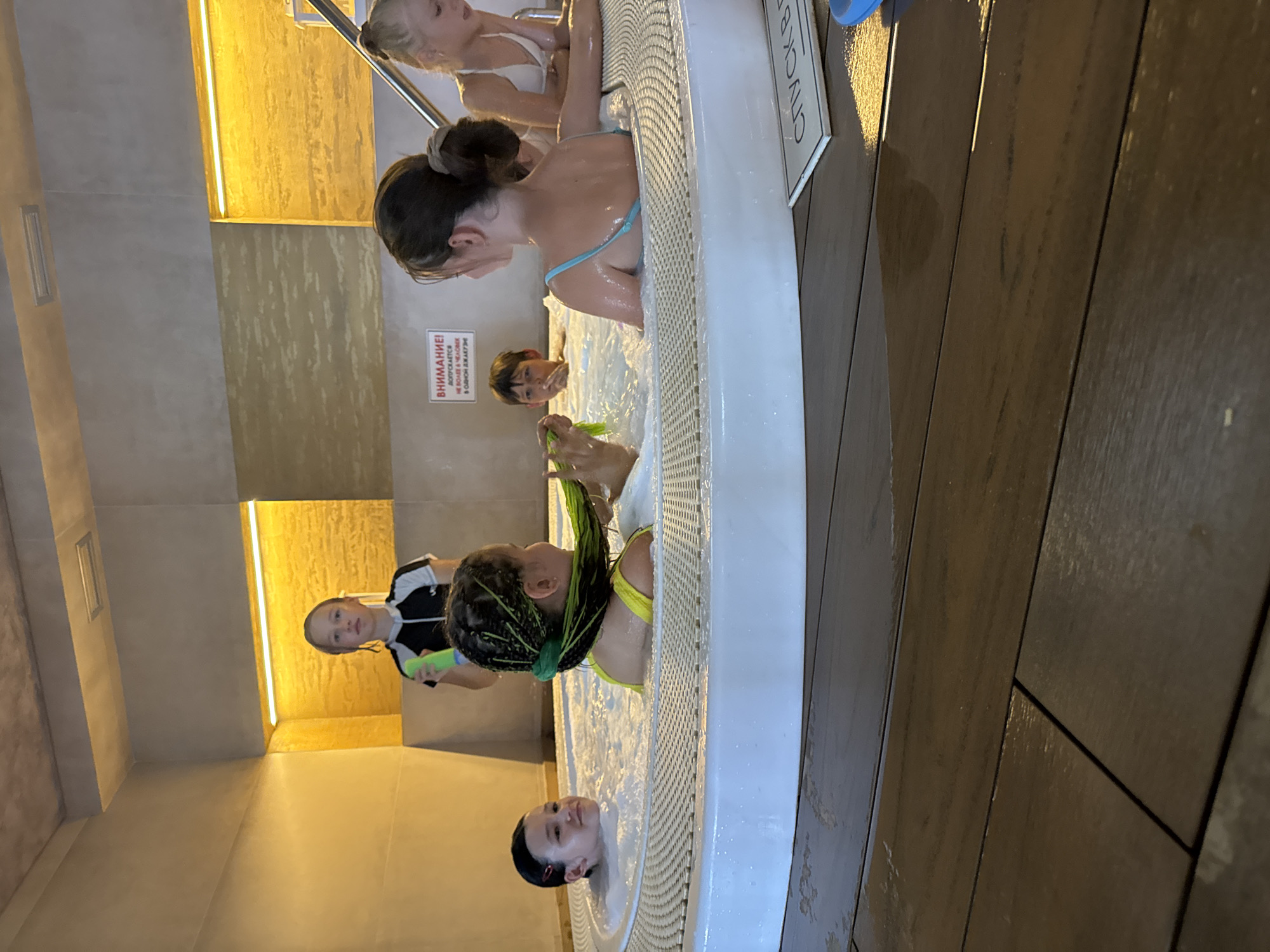 Kids and guests enjoying an indoor pool facility in Yevpatoriya