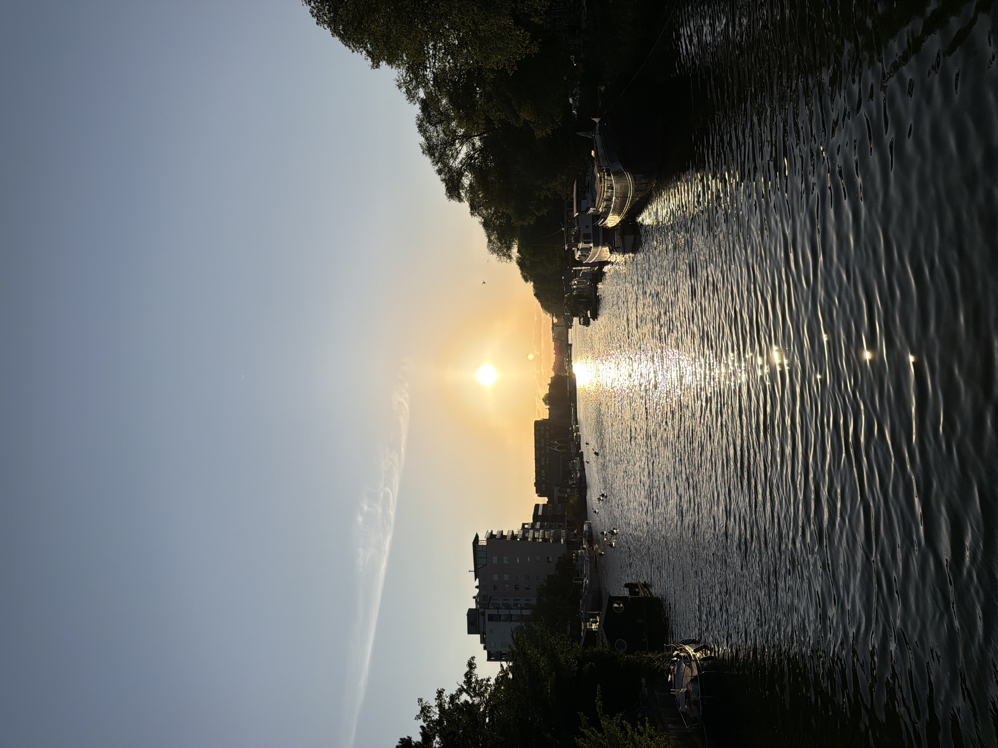 Golden hour on an Amsterdam canal, bikes and houseboats