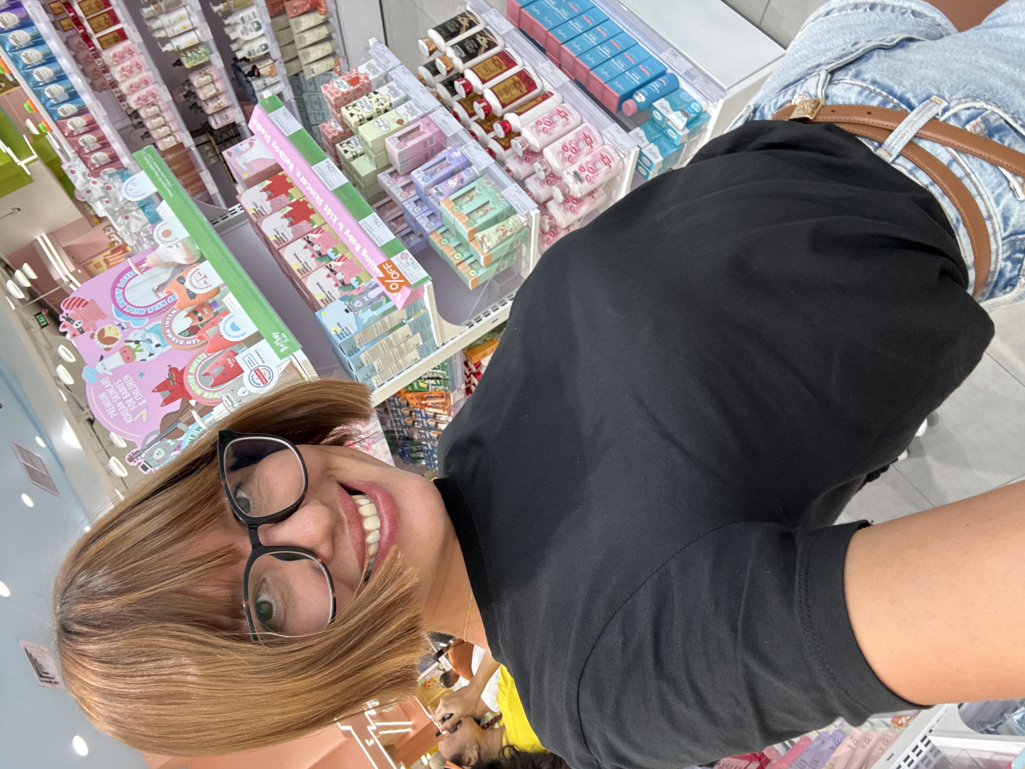 Woman takes selfie in skincare store in Kuta