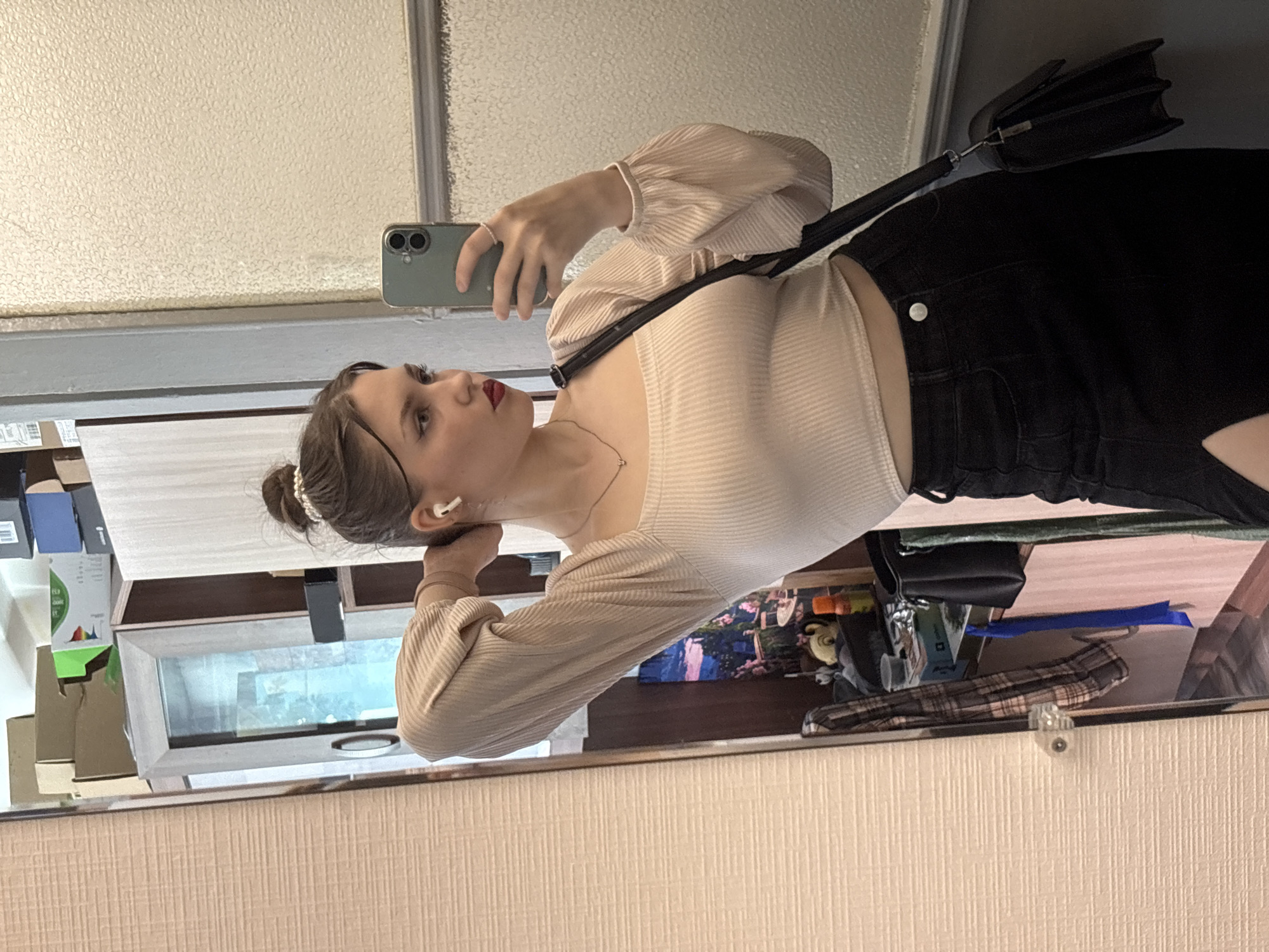 Young woman photographs herself indoors in Saint Petersburg