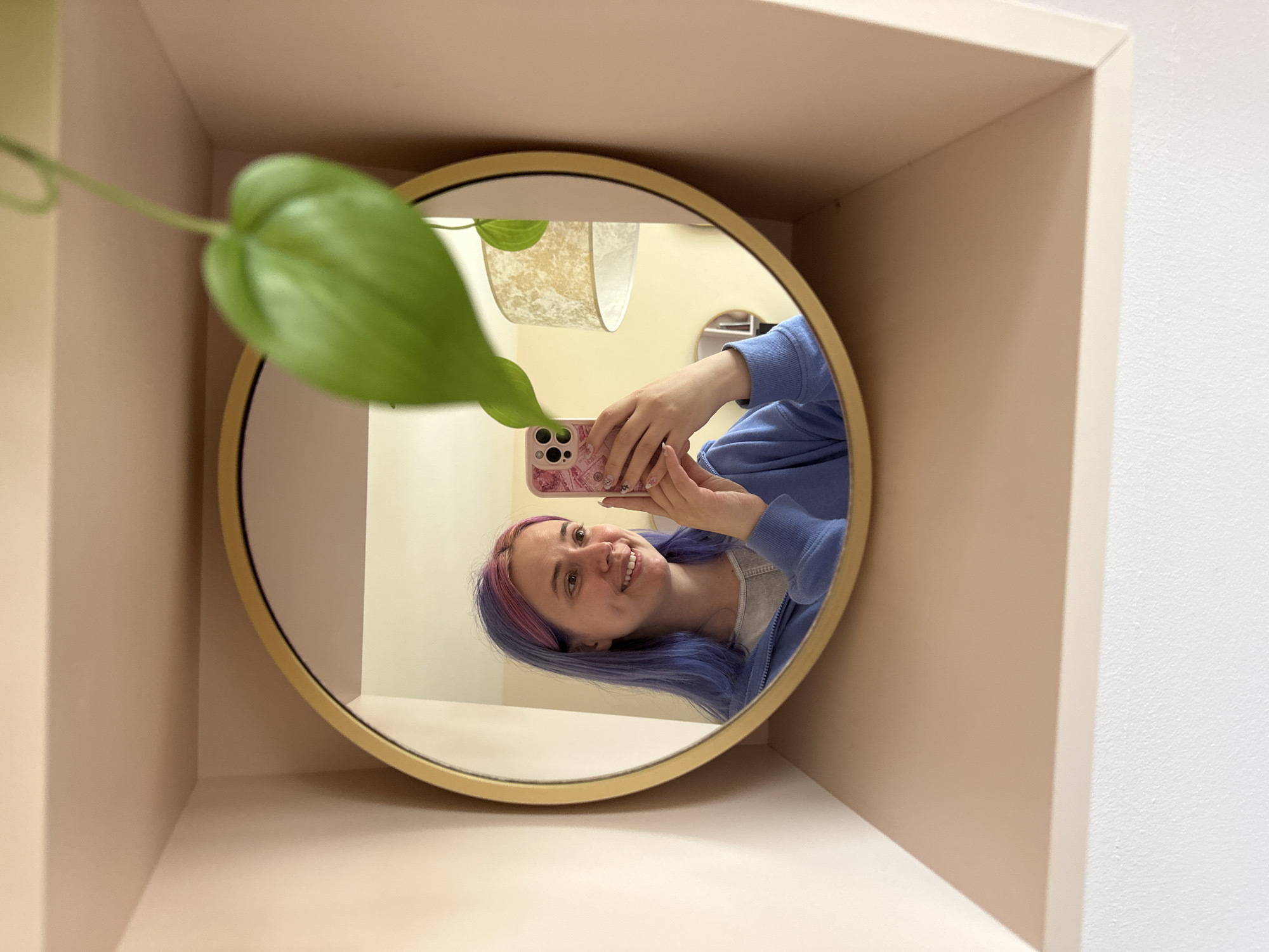 Woman takes bathroom mirror selfies in Gijón, Spain