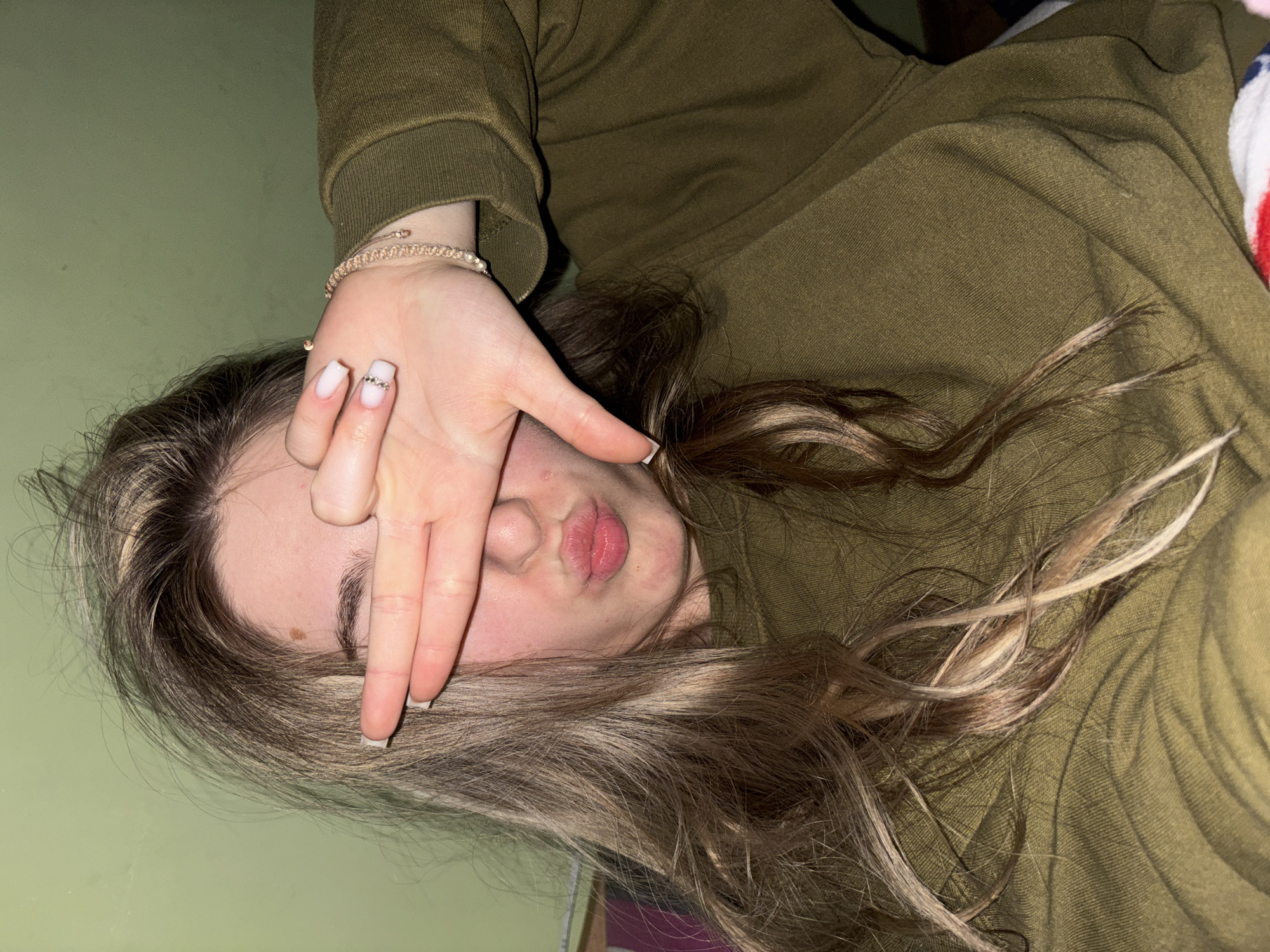 Person resting with decorated nails observed in casual moment