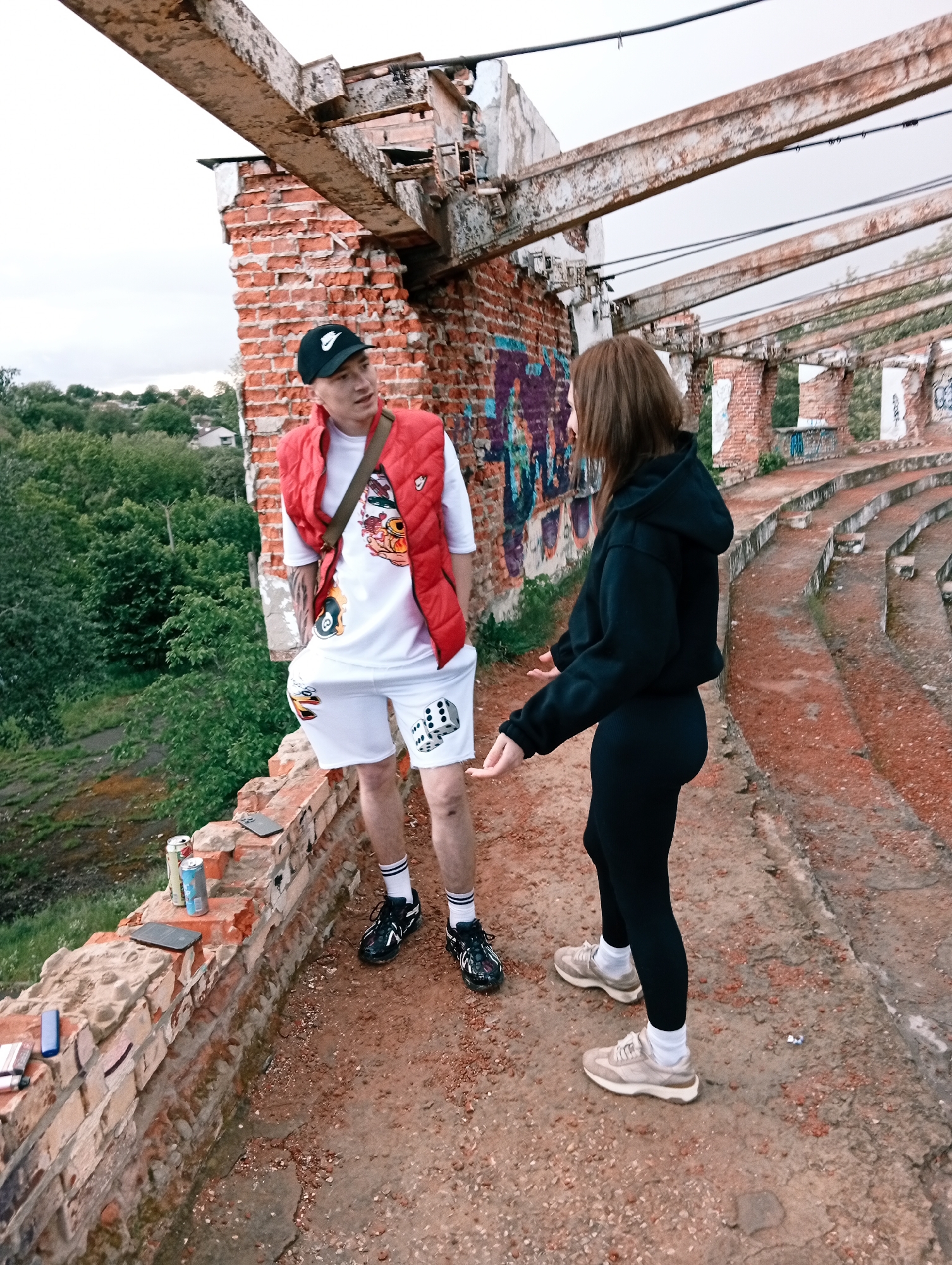 Young people explore abandoned stadium ruins in Poltava, Ukraine