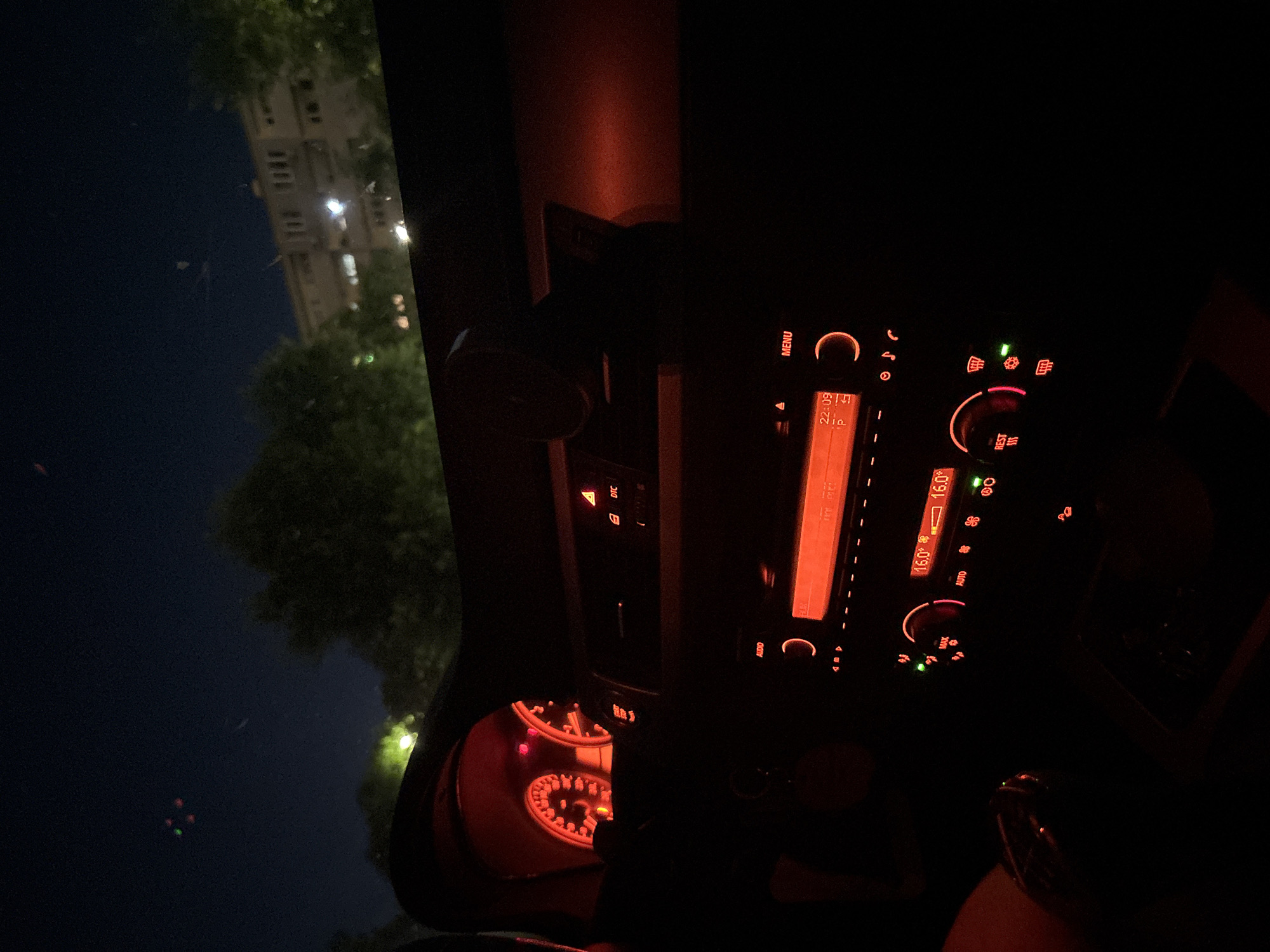 Parked outside a Lidl at night, killing time in the car