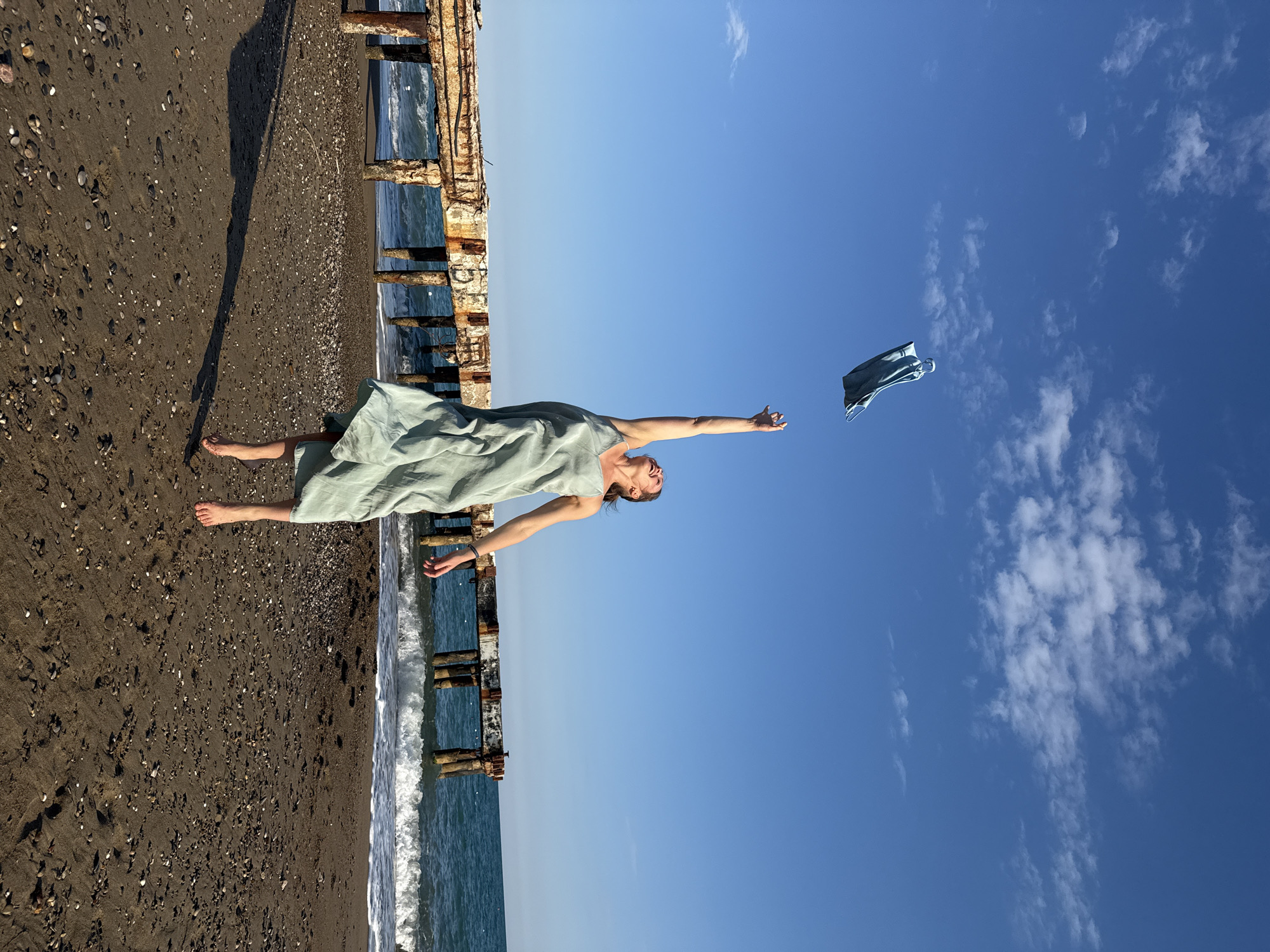 Woman poses on damaged pier structure in Serik, Turkey