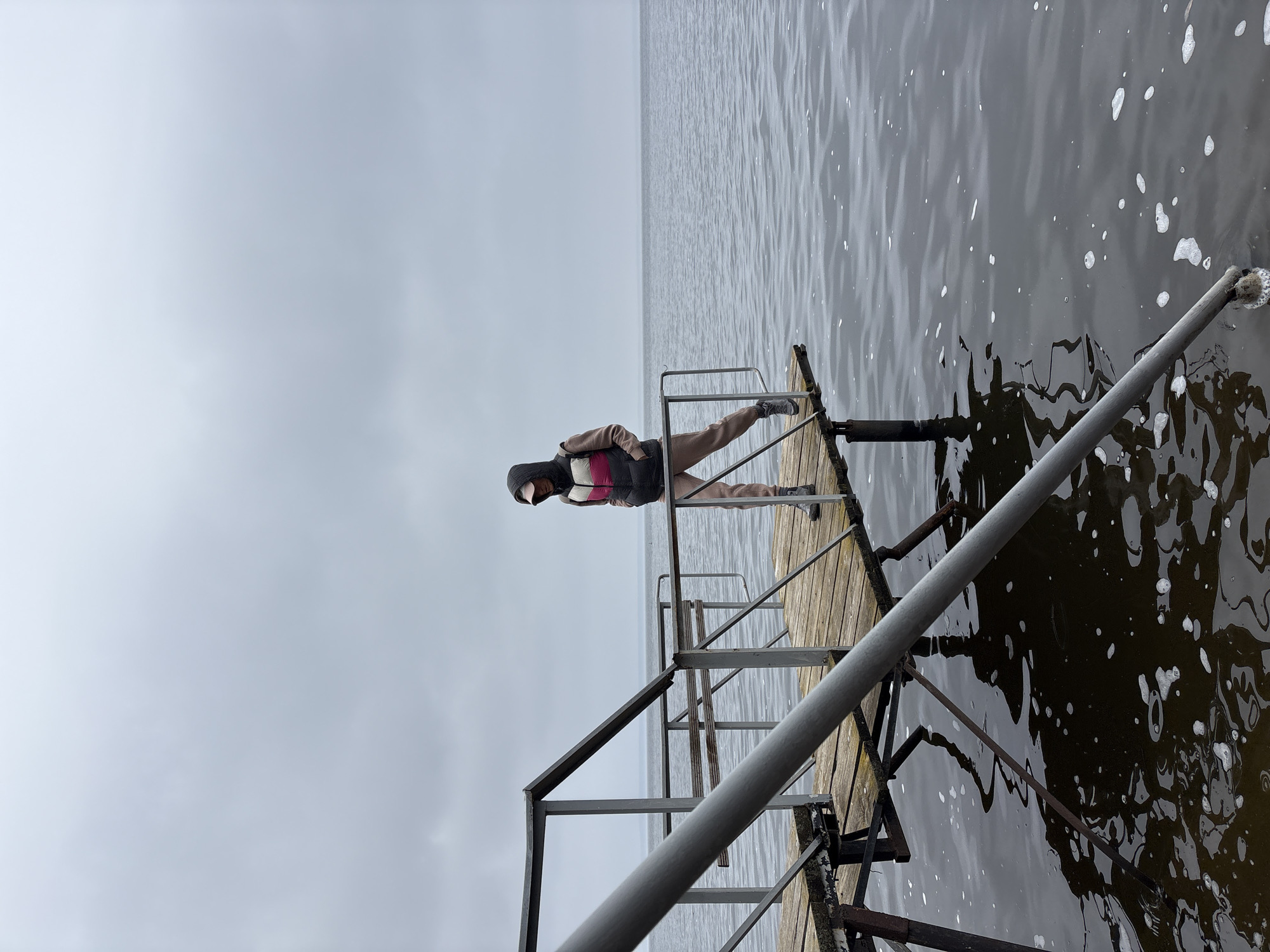 Person sits on pier edge in Ulyanovsk, Russia