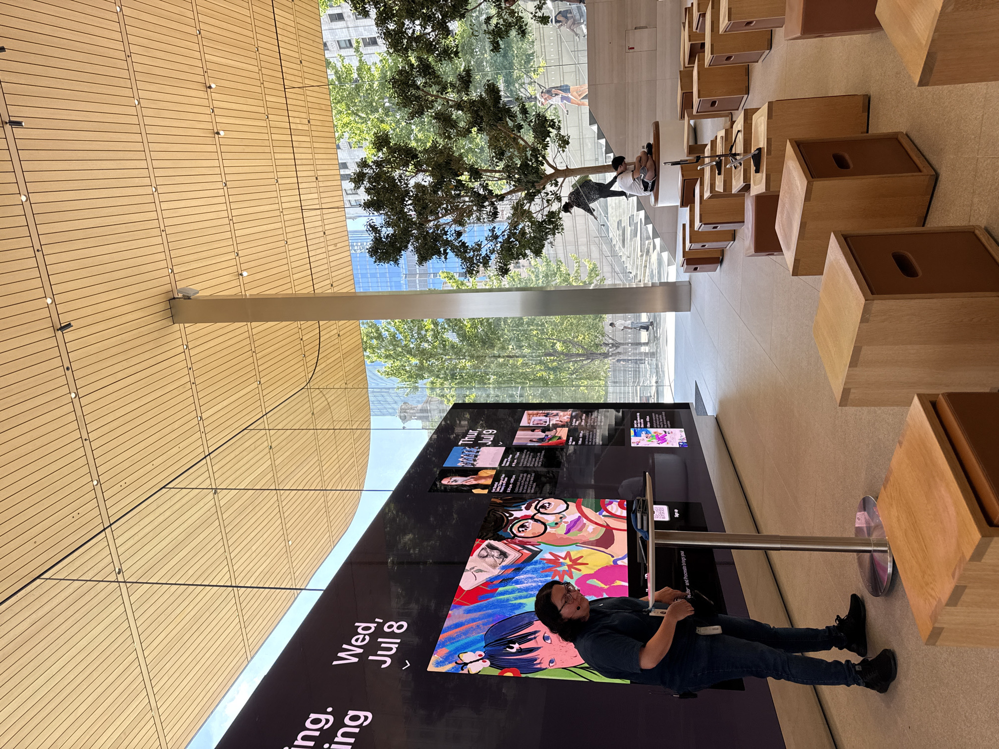 Inside and outside Apple's Michigan Avenue store on a summer evening
