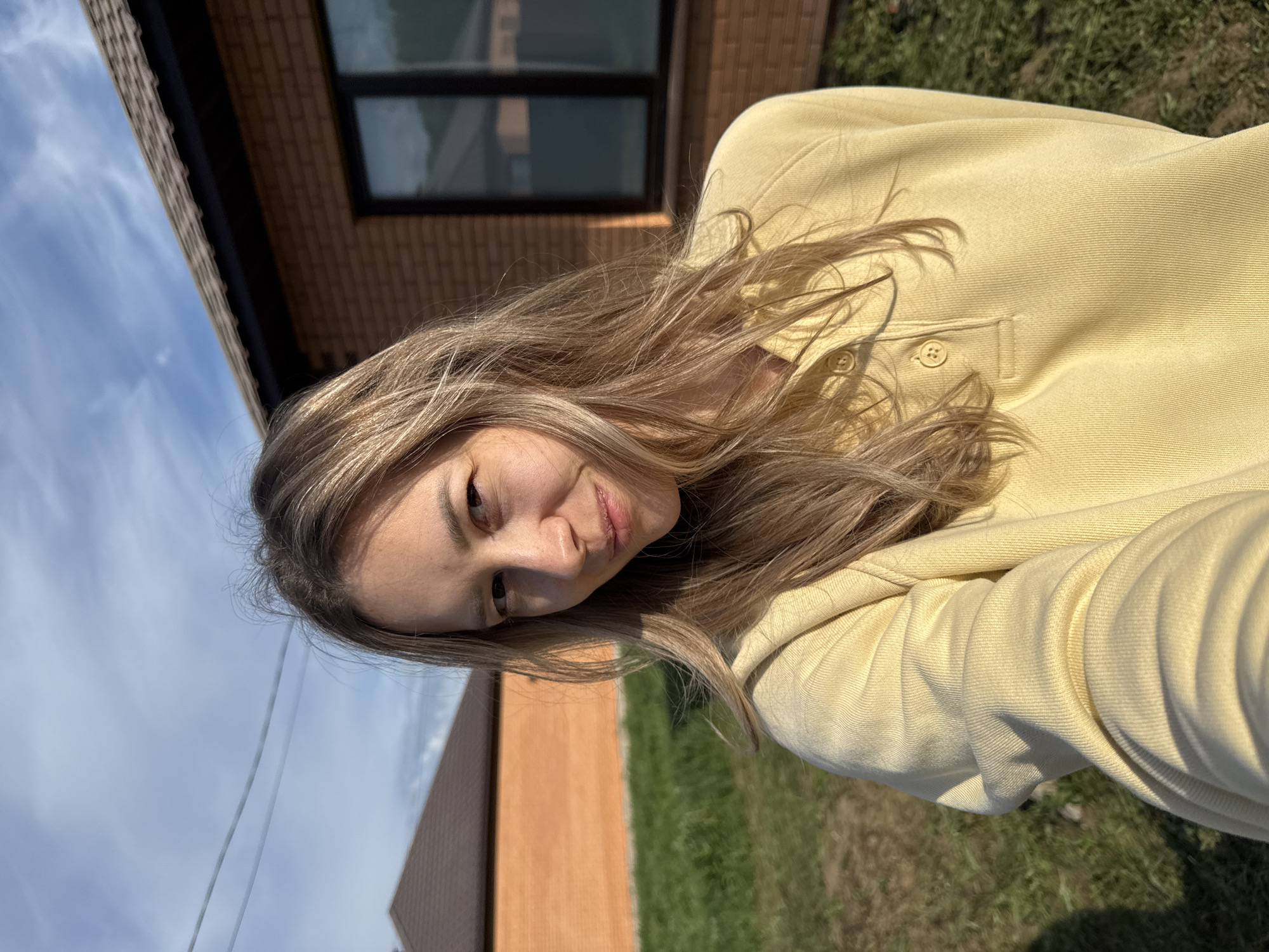 Woman photographed smiling outside brick building in Chaikovsky, Russia