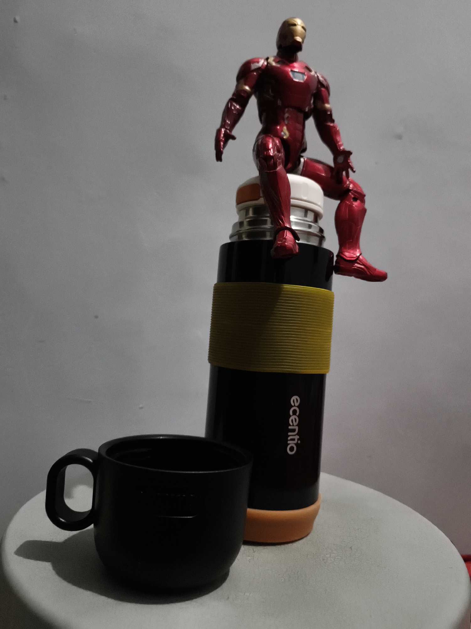 Iron Man action figure staged across everyday objects in Petiken